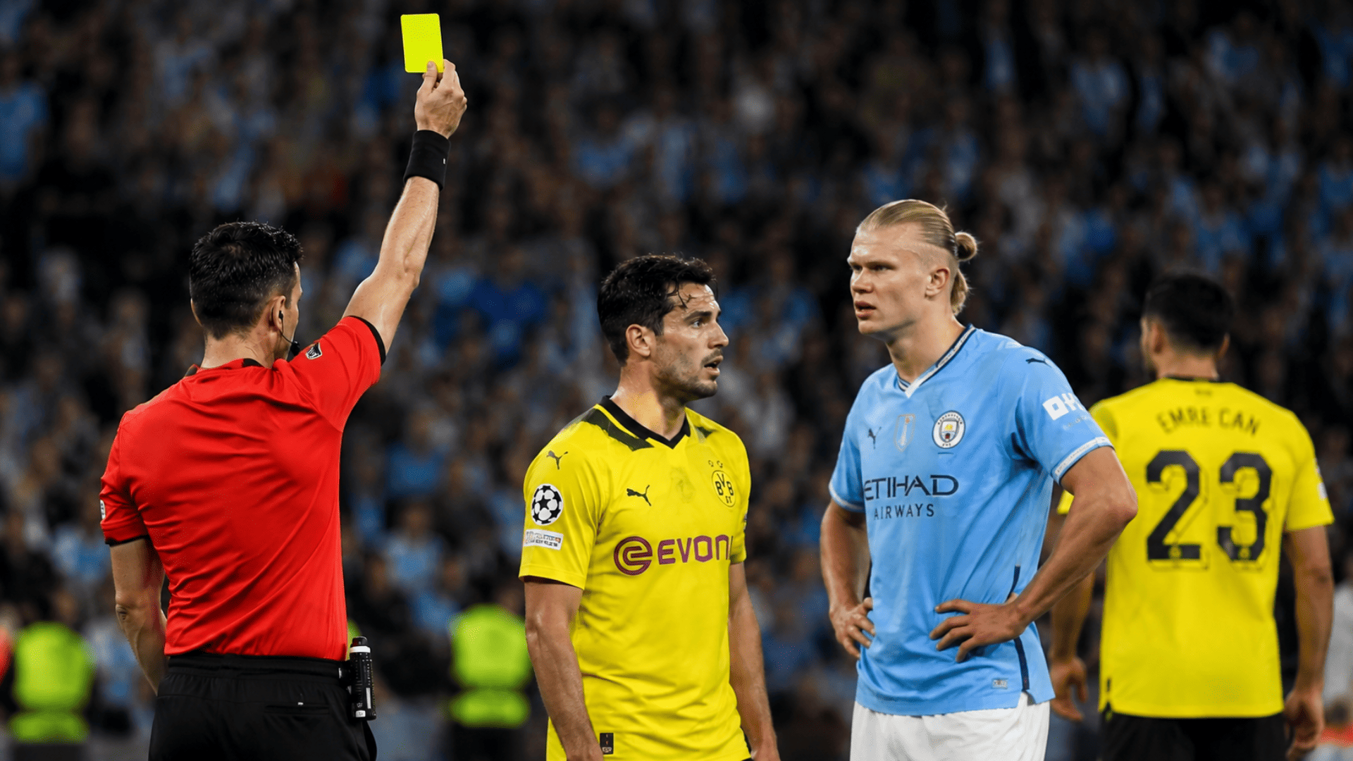 Referee issuing a yellow card to a player during a high-intensity soccer game in a packed stadium