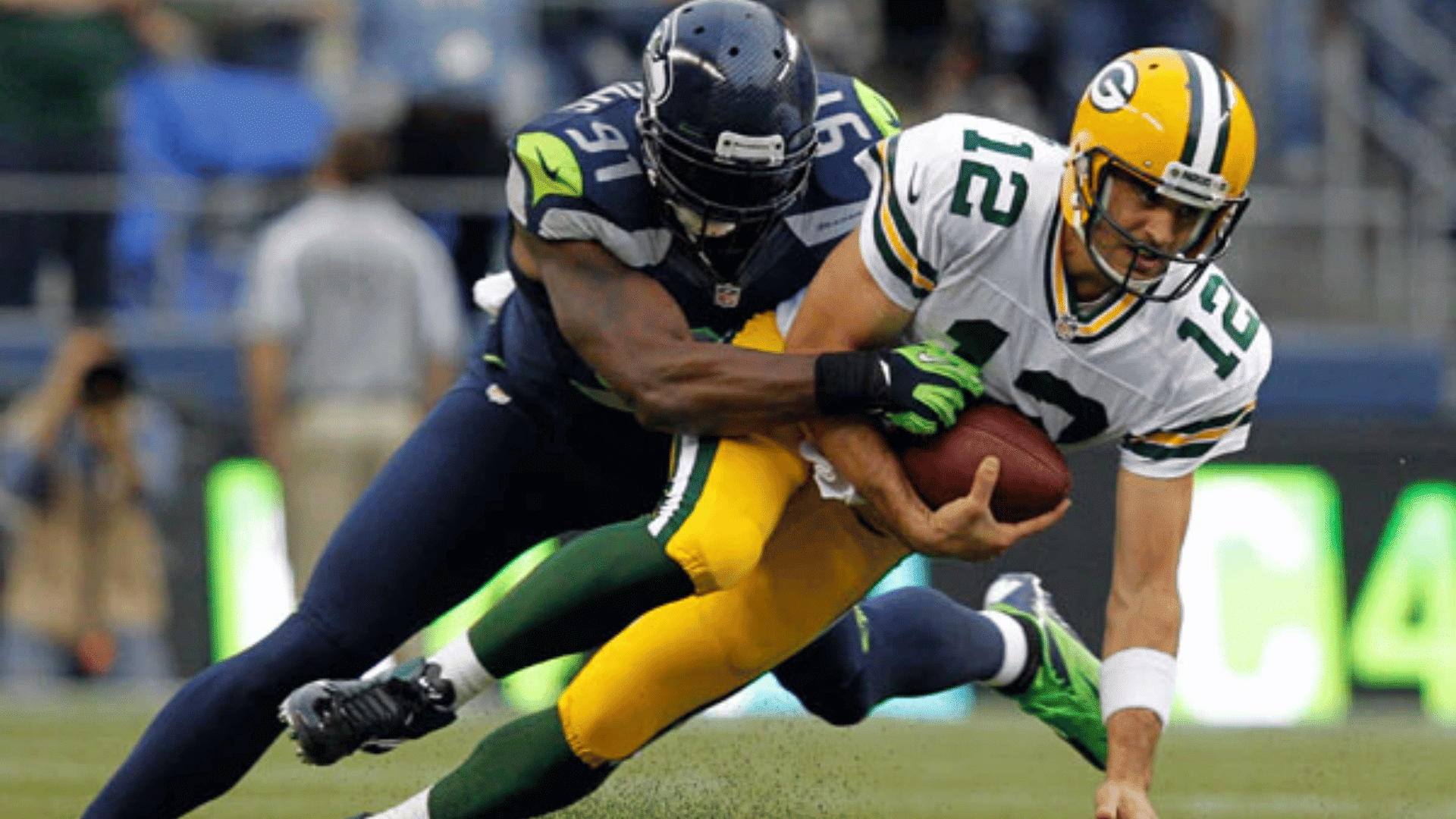 a defensive tackle by blue jersey number sixteen against white jersey number twelve
