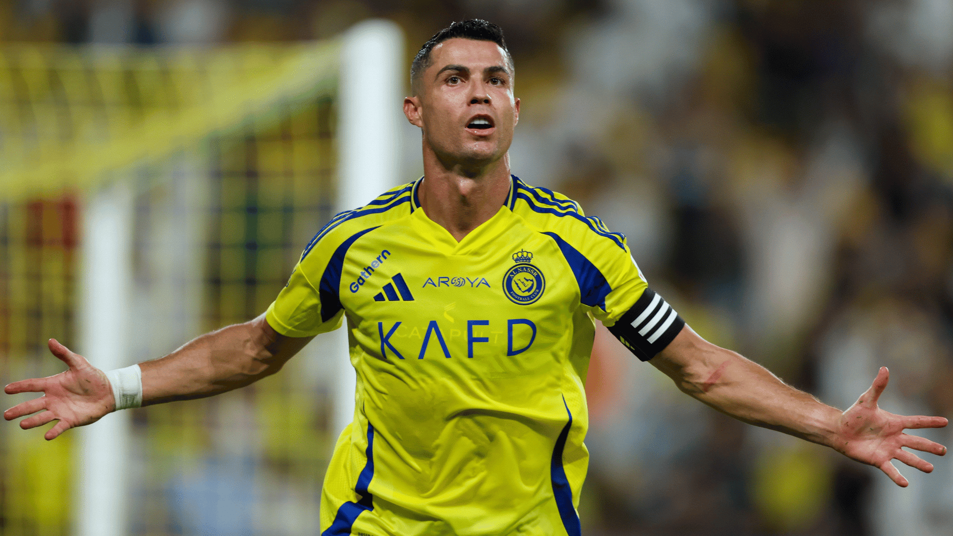 christiano ronaldo in his iconic all nassr jersey celebrating his goal arms spread wide in to the distance with immense aura