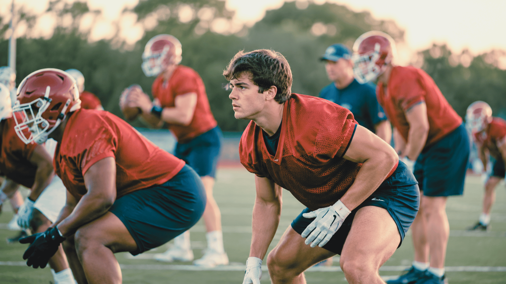 college athlete participating in team activities while watching practice from the sideline