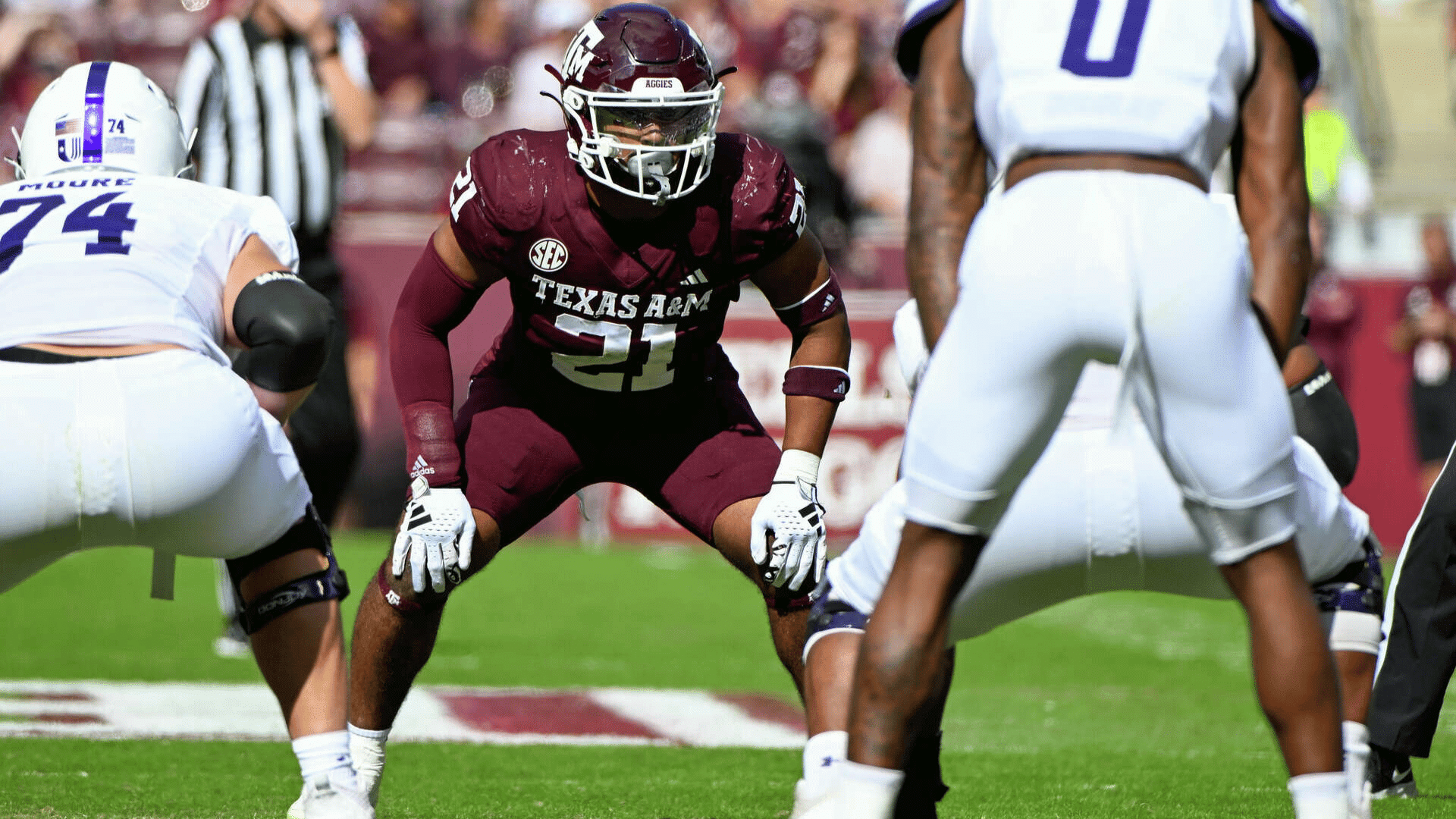 college football players from texas a and m in maroon and colorado in white facing each other on the field