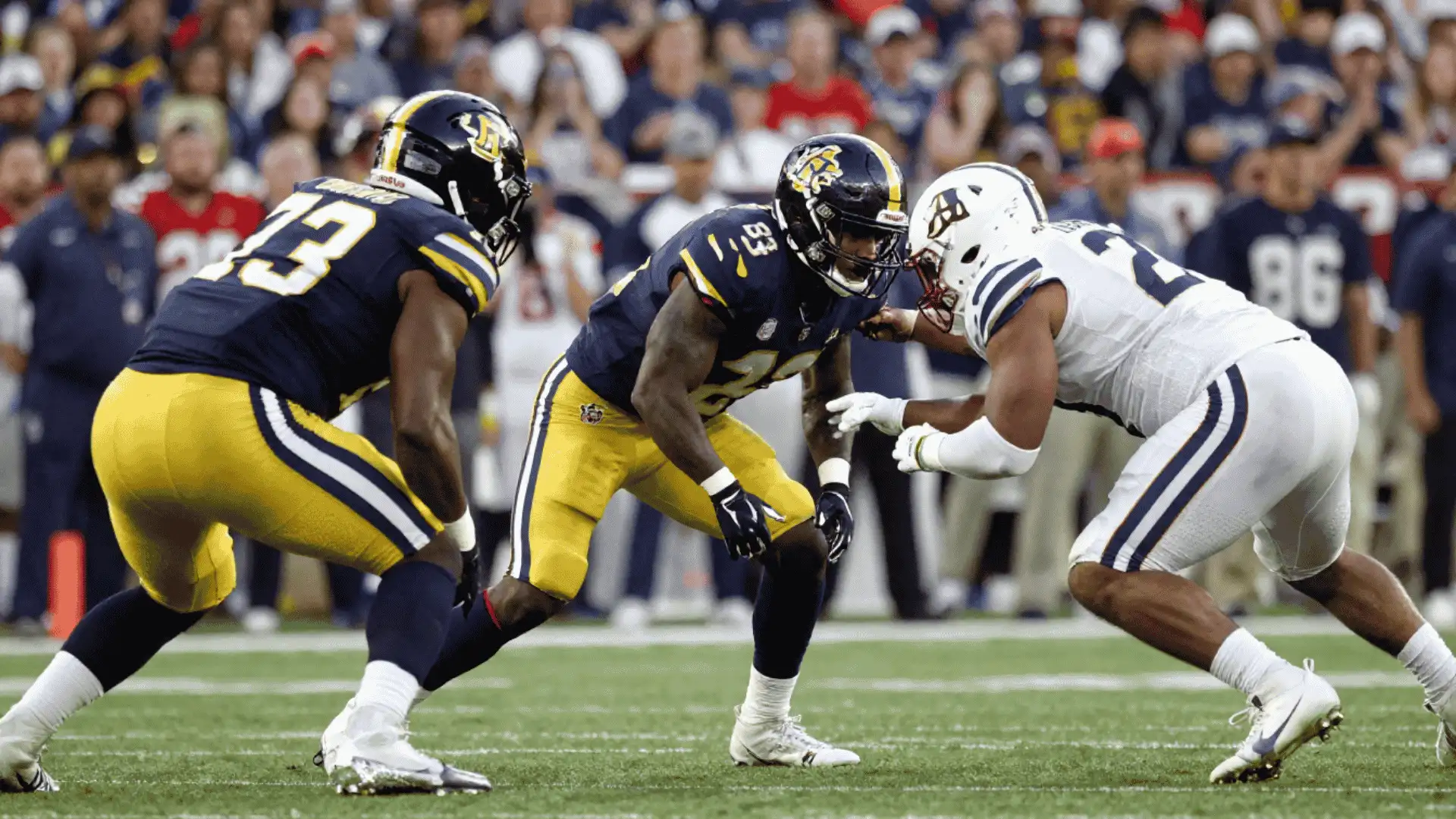 football players lining up before a play while defenders prepare coverage assignments during game action