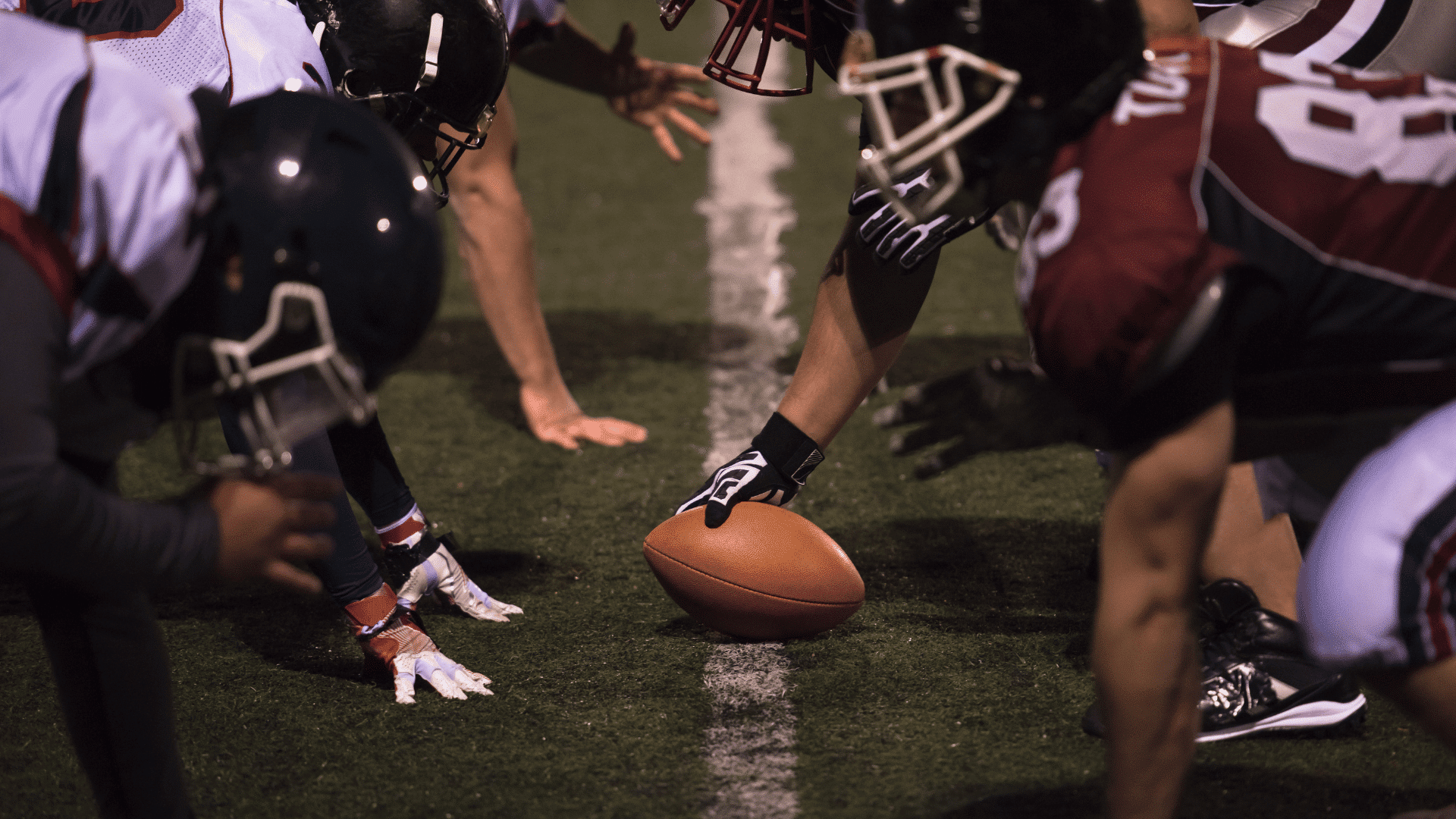 defensive back turning toward the football while breaking up a deep pass near the receiver in coverage