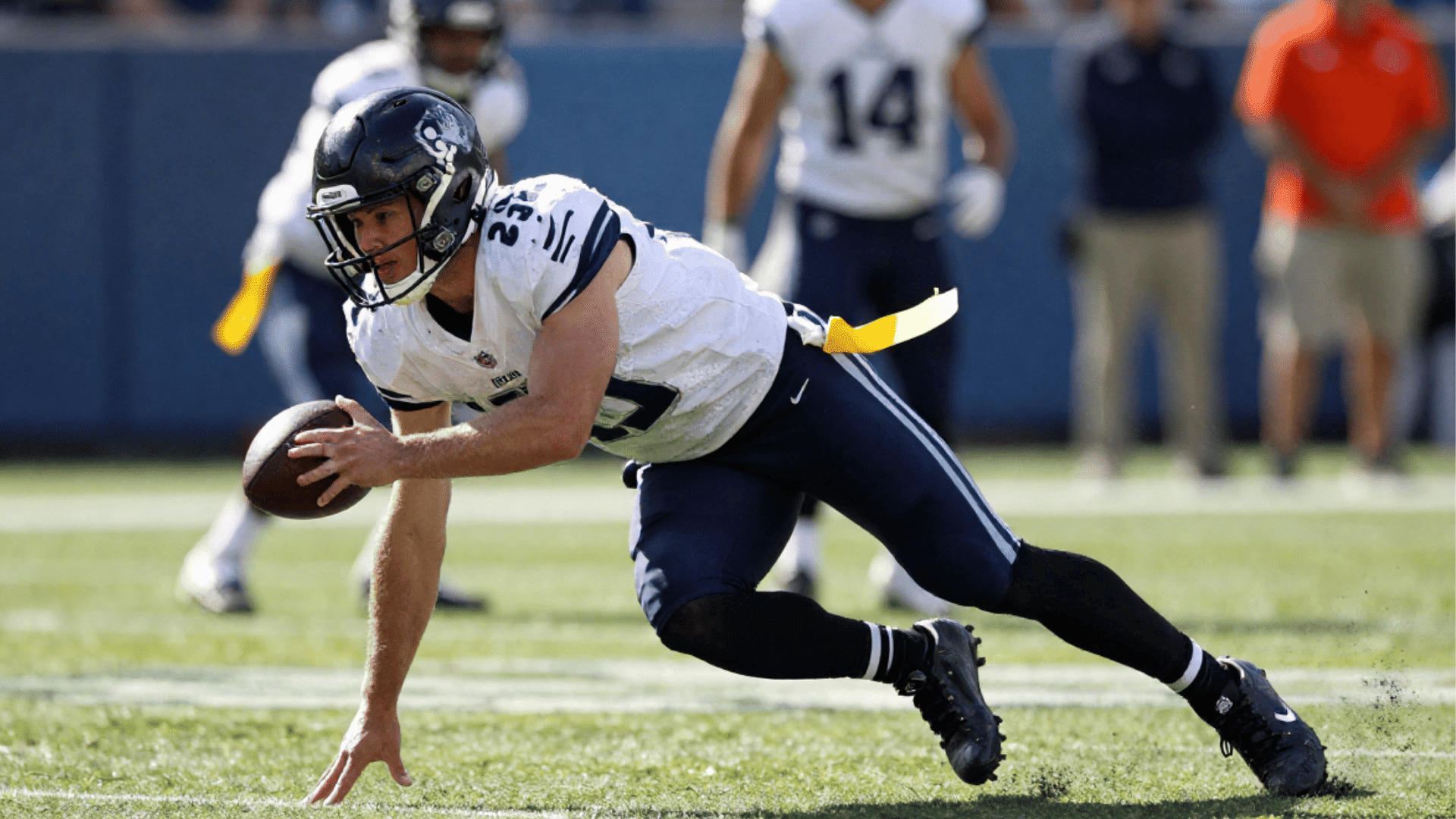 defensive rusher bursting off the line to pressure the quarterback