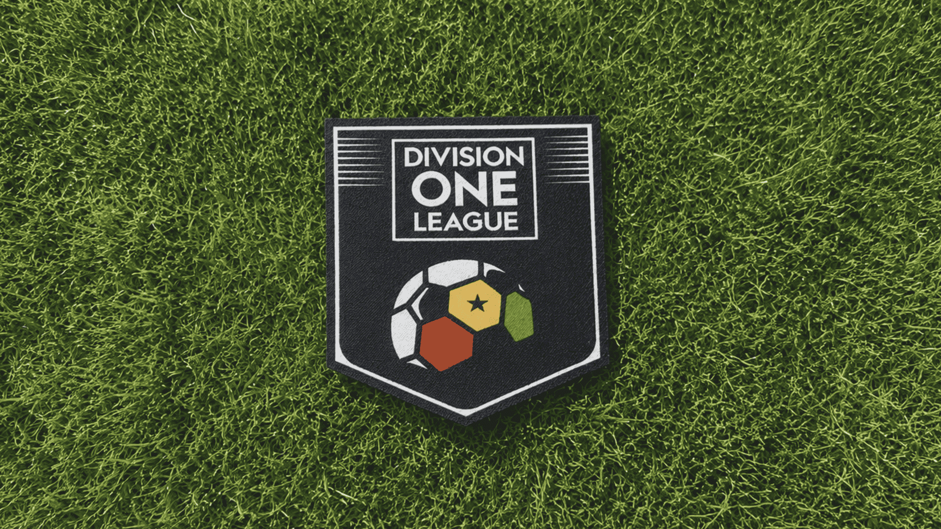 division one league football badge placed on green grass with realistic turf and natural lighting