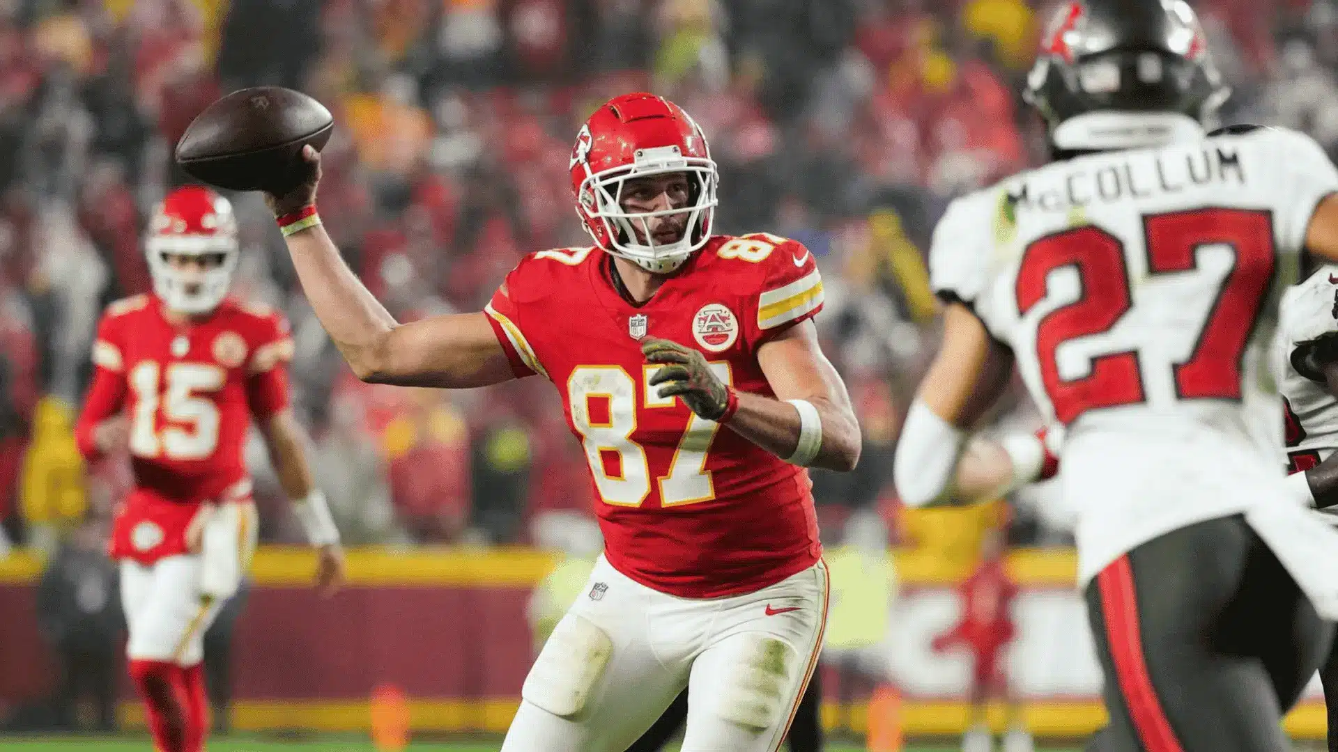 football player throwing a pass during a live game with defenders and teammates around him on the field