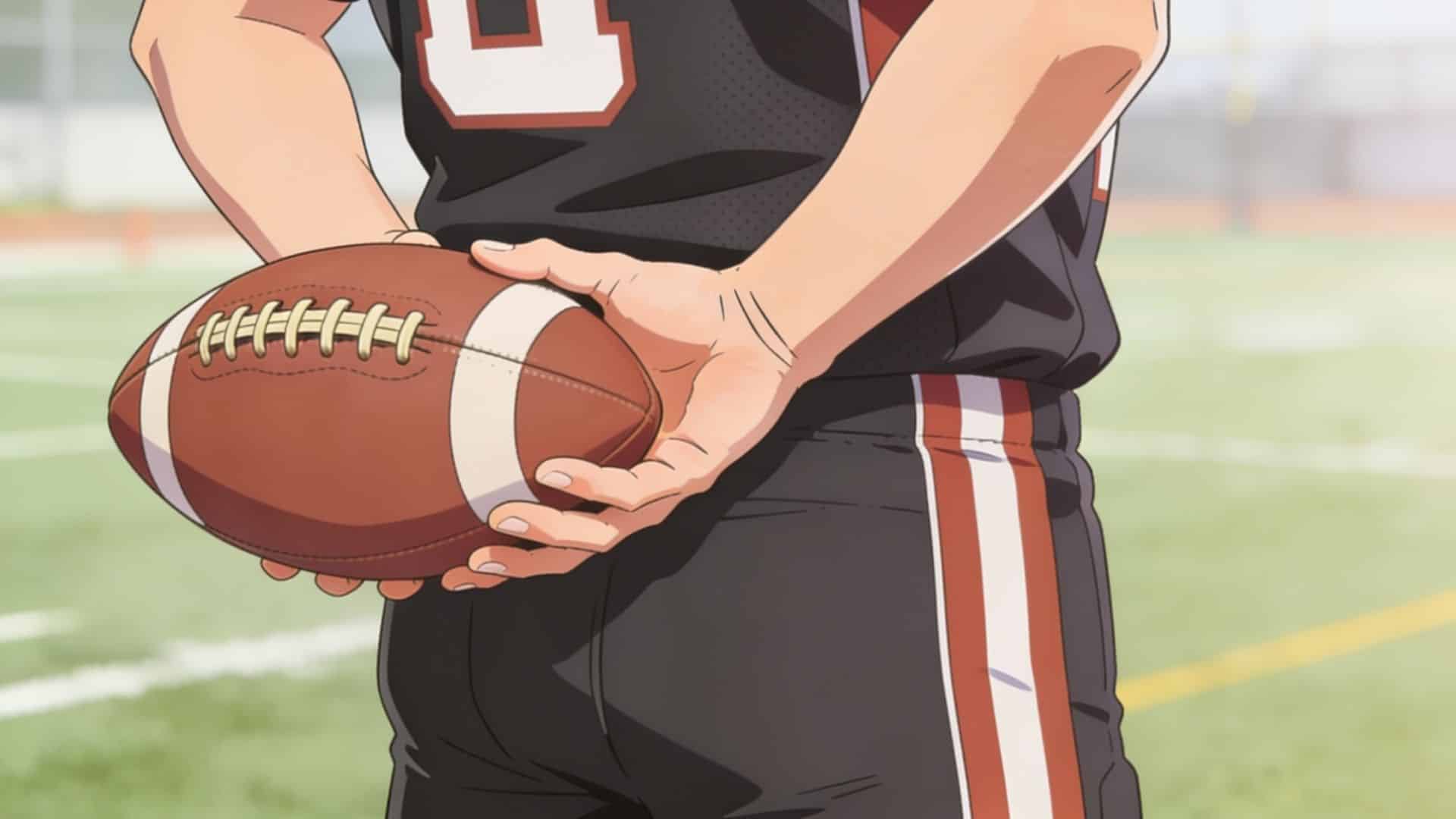 football player holding a brown football with both hands on a sunny field before making a pass