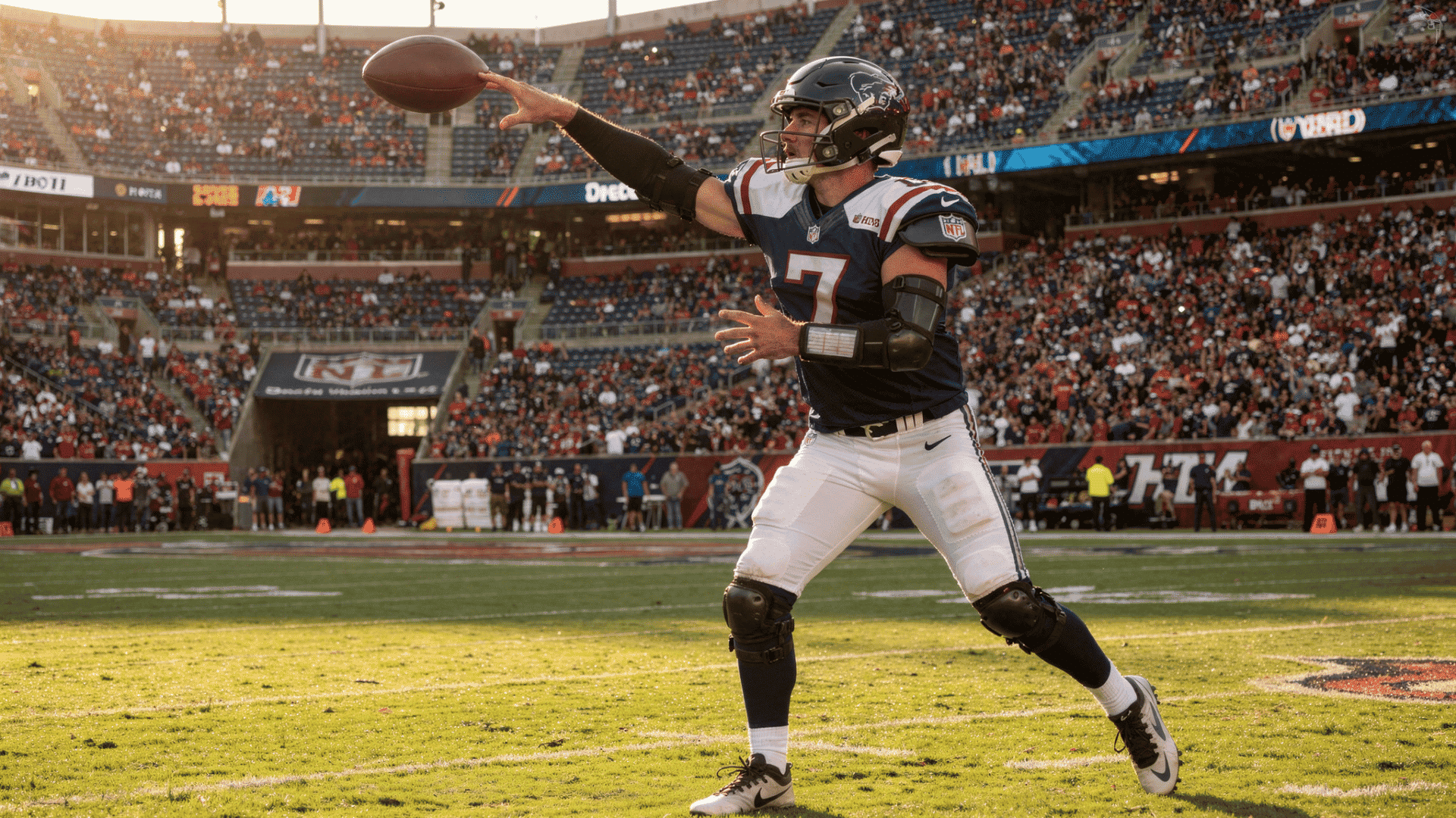 football player in a blue and white uniform throws a football on a sunny day at a stadium