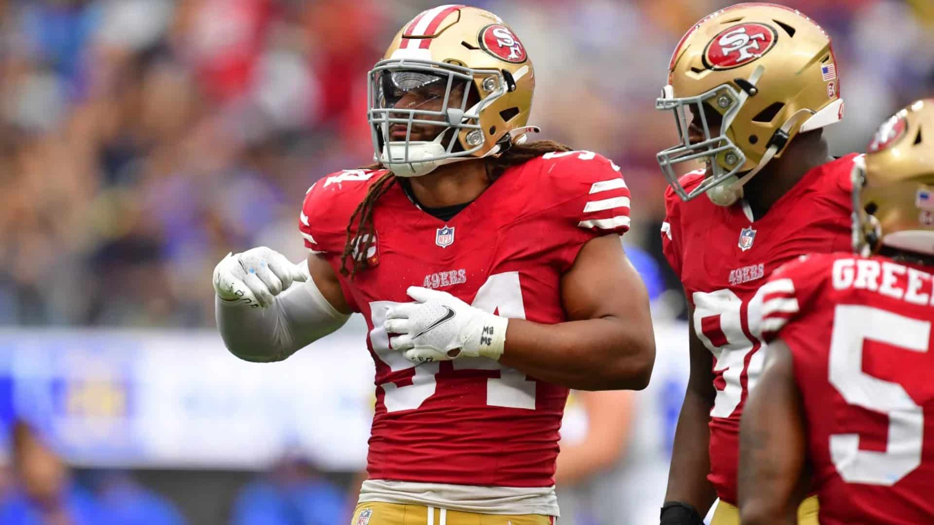 Fred Warner communicating defensive adjustments to teammates before the snap during an NFL game