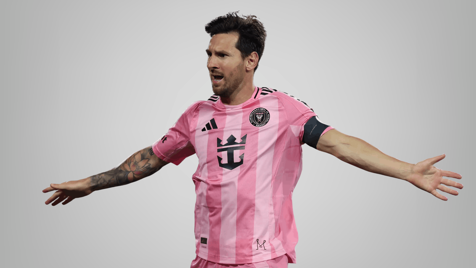 inter miami player in pink jersey celebrating with arms wide on a clean grey background