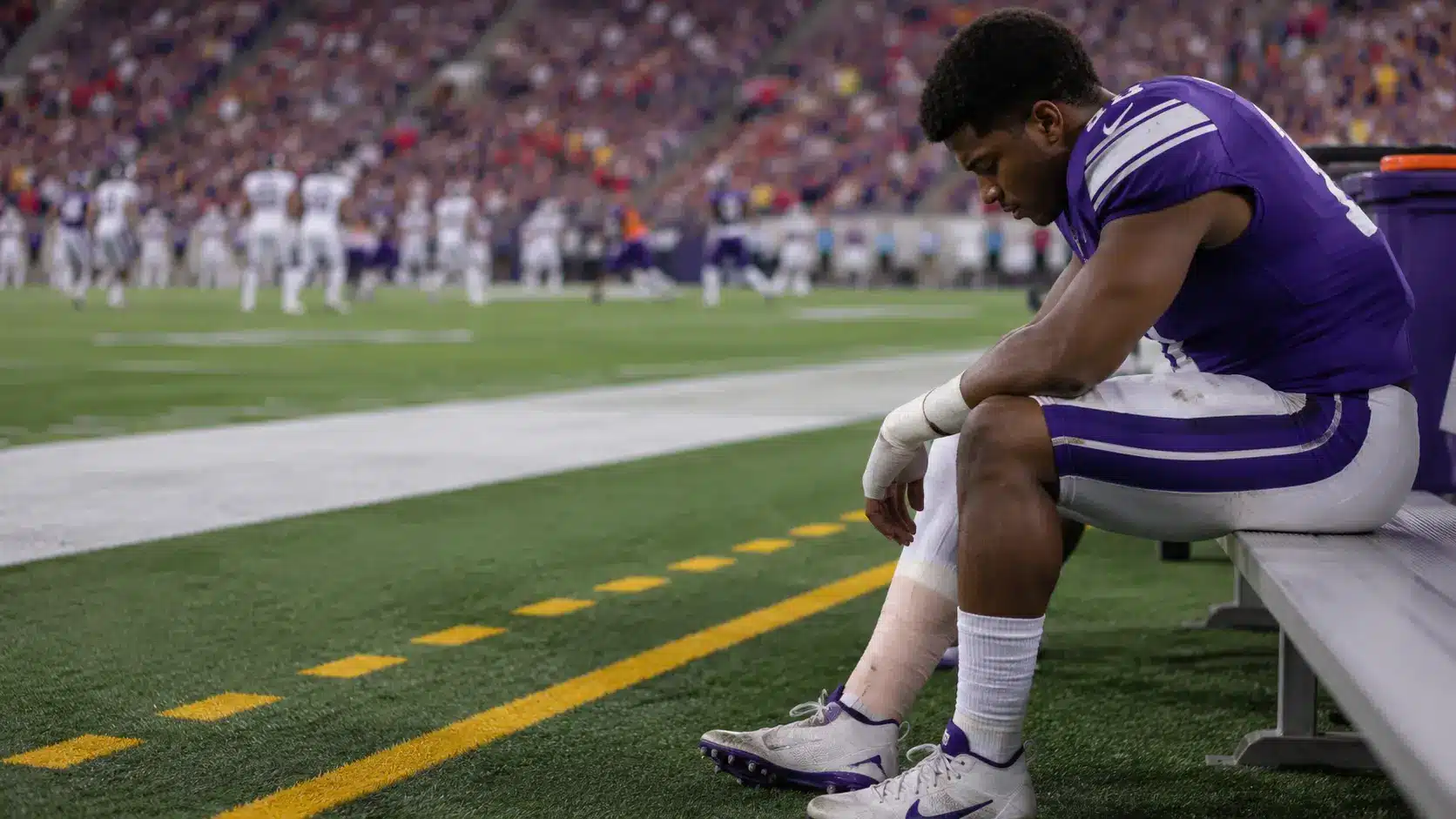 ir in fantasy football shown by an injured player sitting on the sideline while teammates continue playing