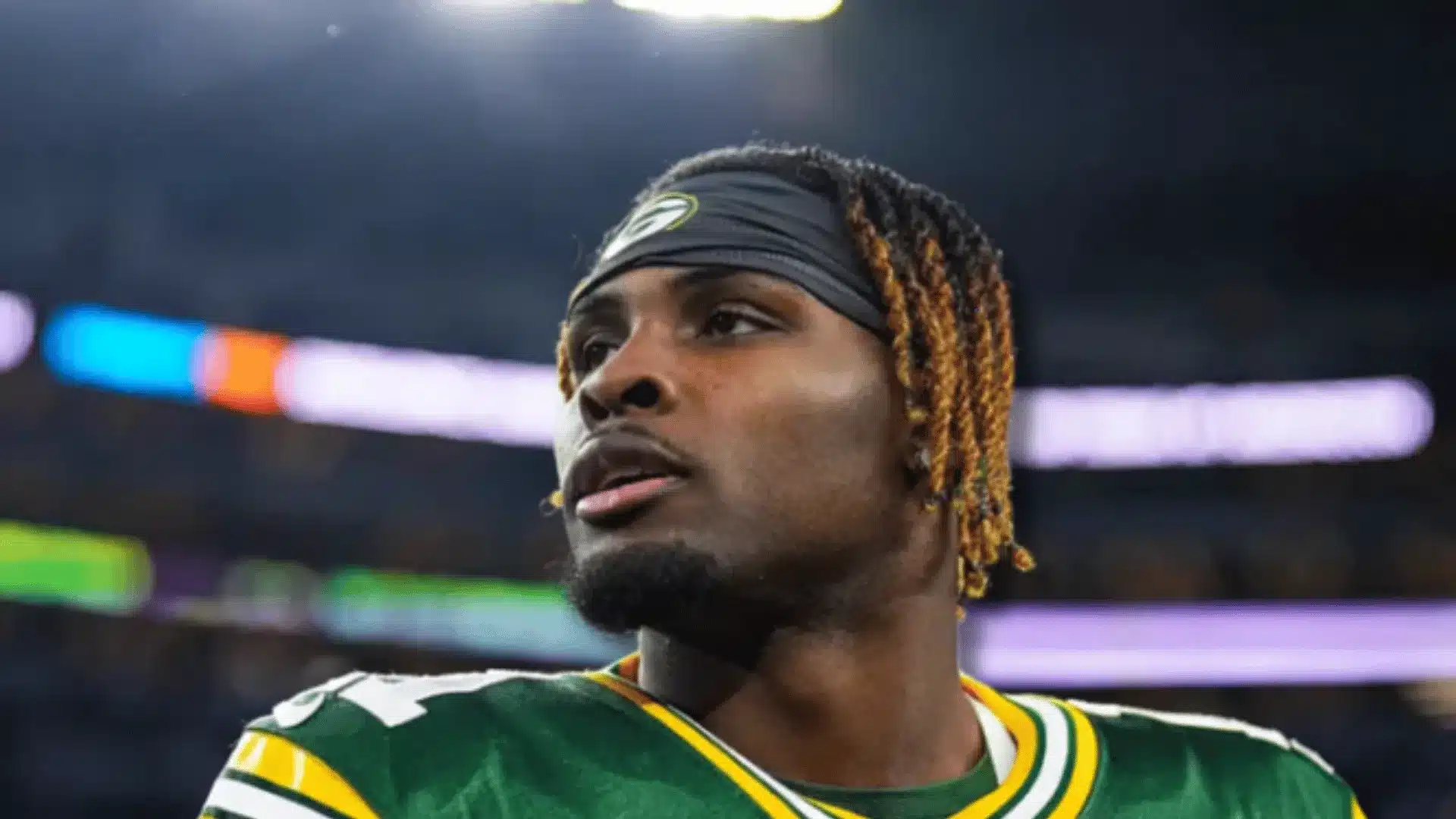 green bay packers wr jayden reed on the sideline in his jersey during a night game