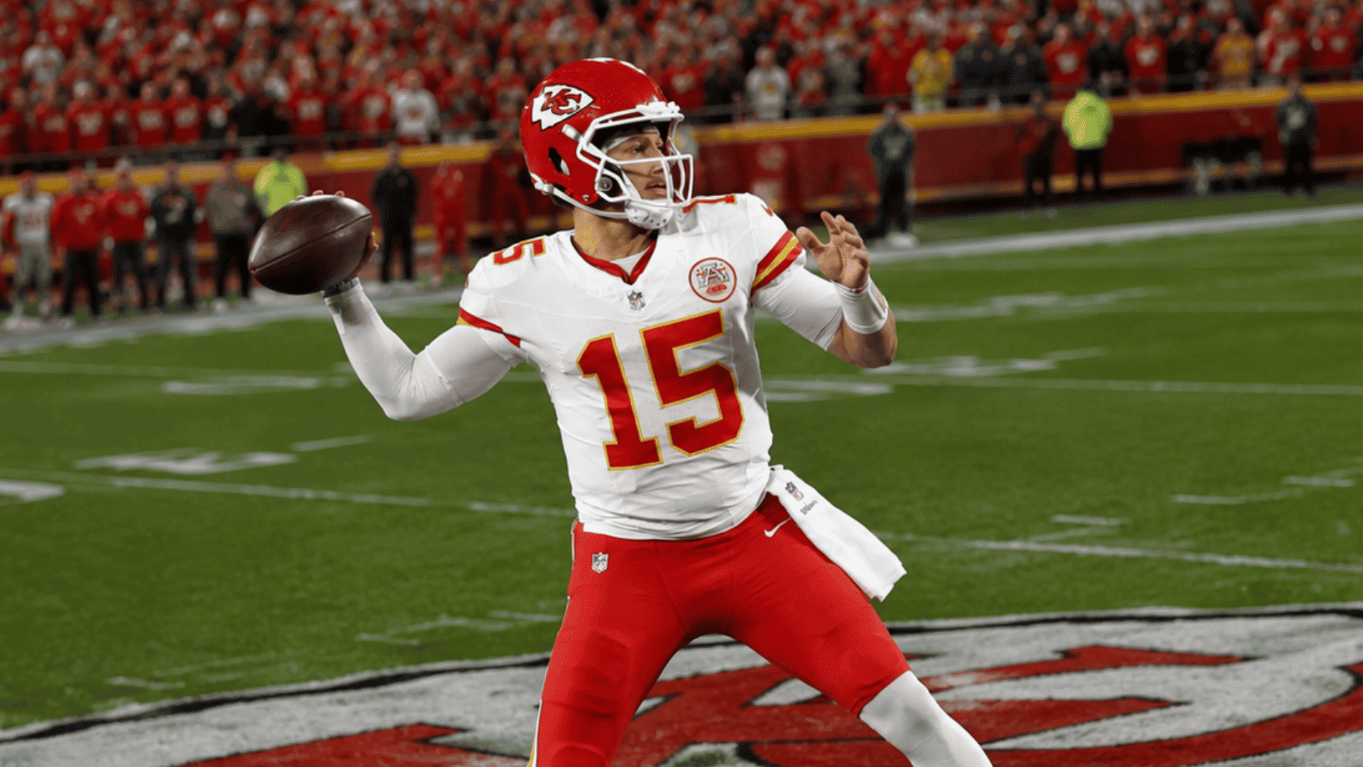 kansas city chiefs quarterback looks downfield while preparing to throw a pass during a professional football game