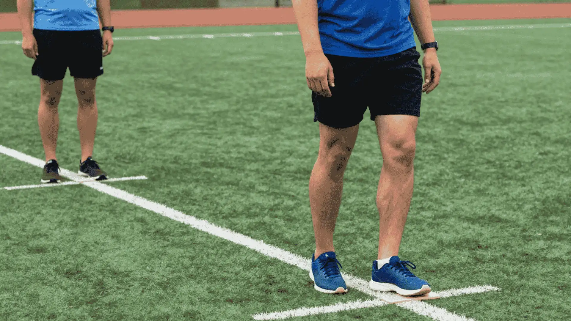 athletes practicing quick chopping steps along a field line during lateral response footwork training