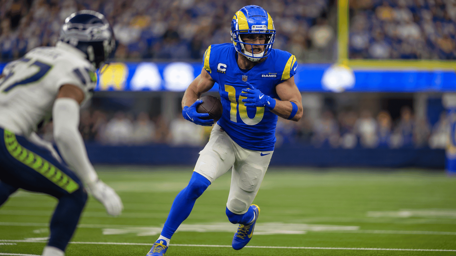 los angeles rams wide receiver carries the football and accelerates through the open field during an nfl game