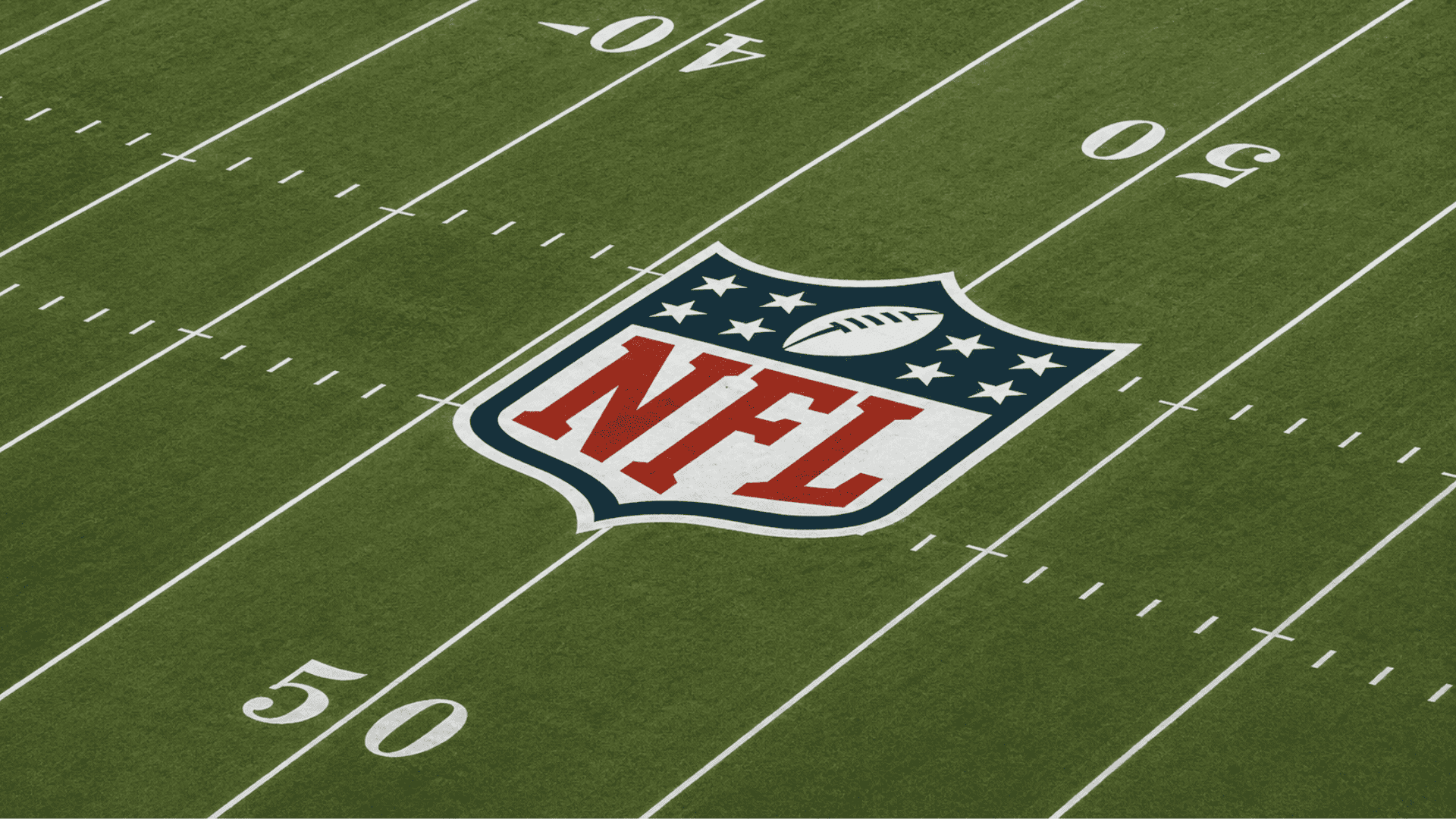 nfl field logo displayed at midfield with yard markings on a professional football field