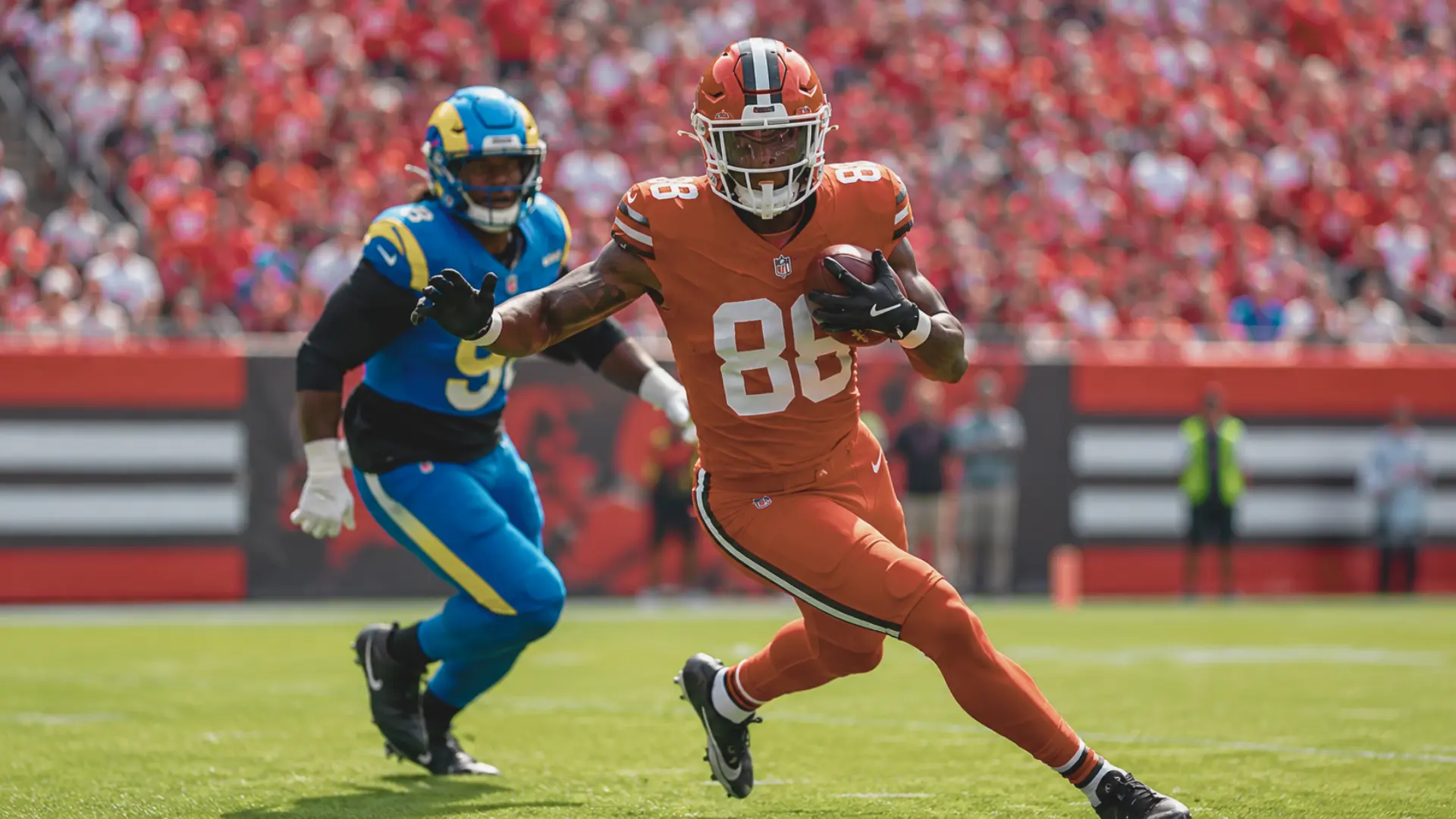 red uniformed ball carrier sprints downfield with the football as a defender gives chase in bright game action