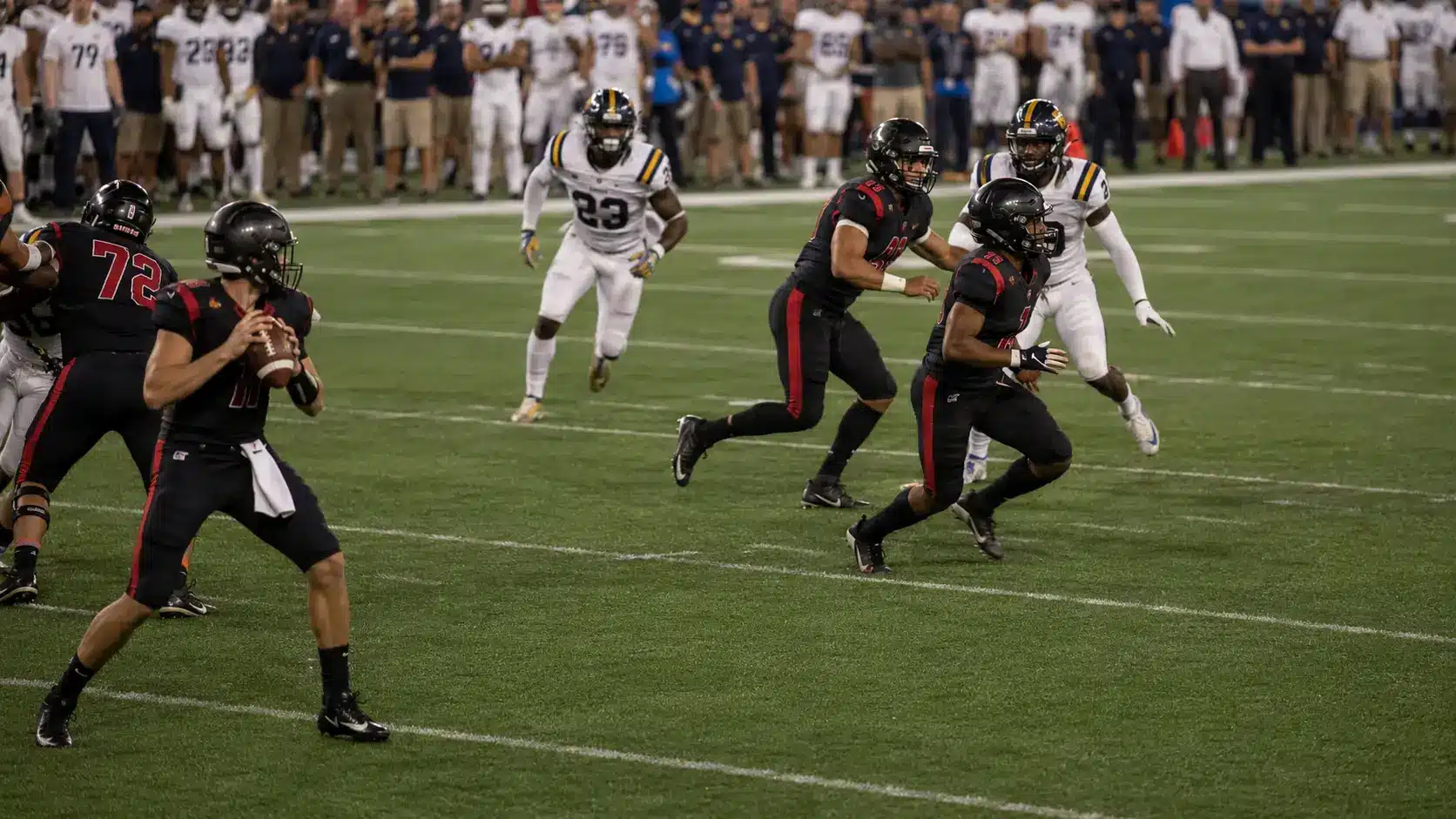 quarterback watches two shallow crossers work through traffic as defenders chase through the mesh point.