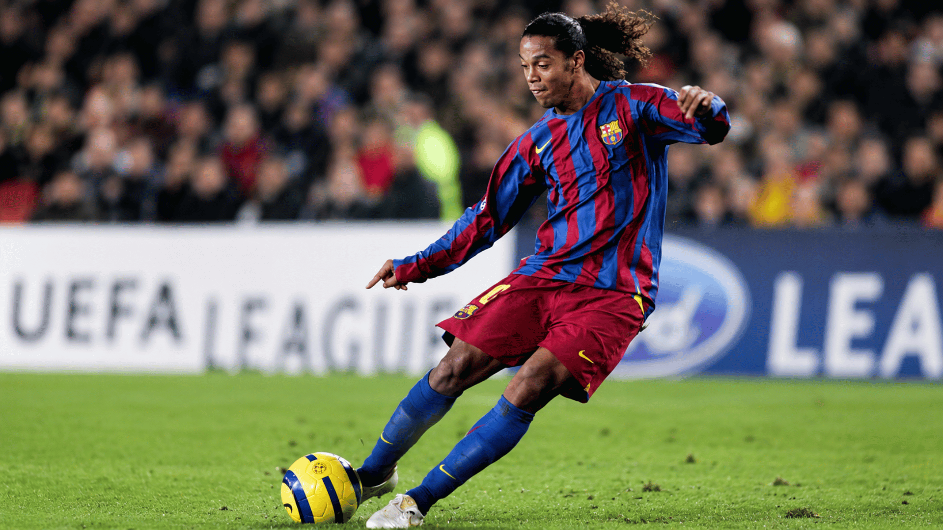 ronaldinho playing for barcelona during a football match while controlling the ball on the pitch