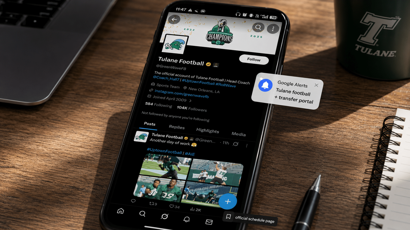smartphone displaying tulane football x account with recruiting updates and alerts on desk