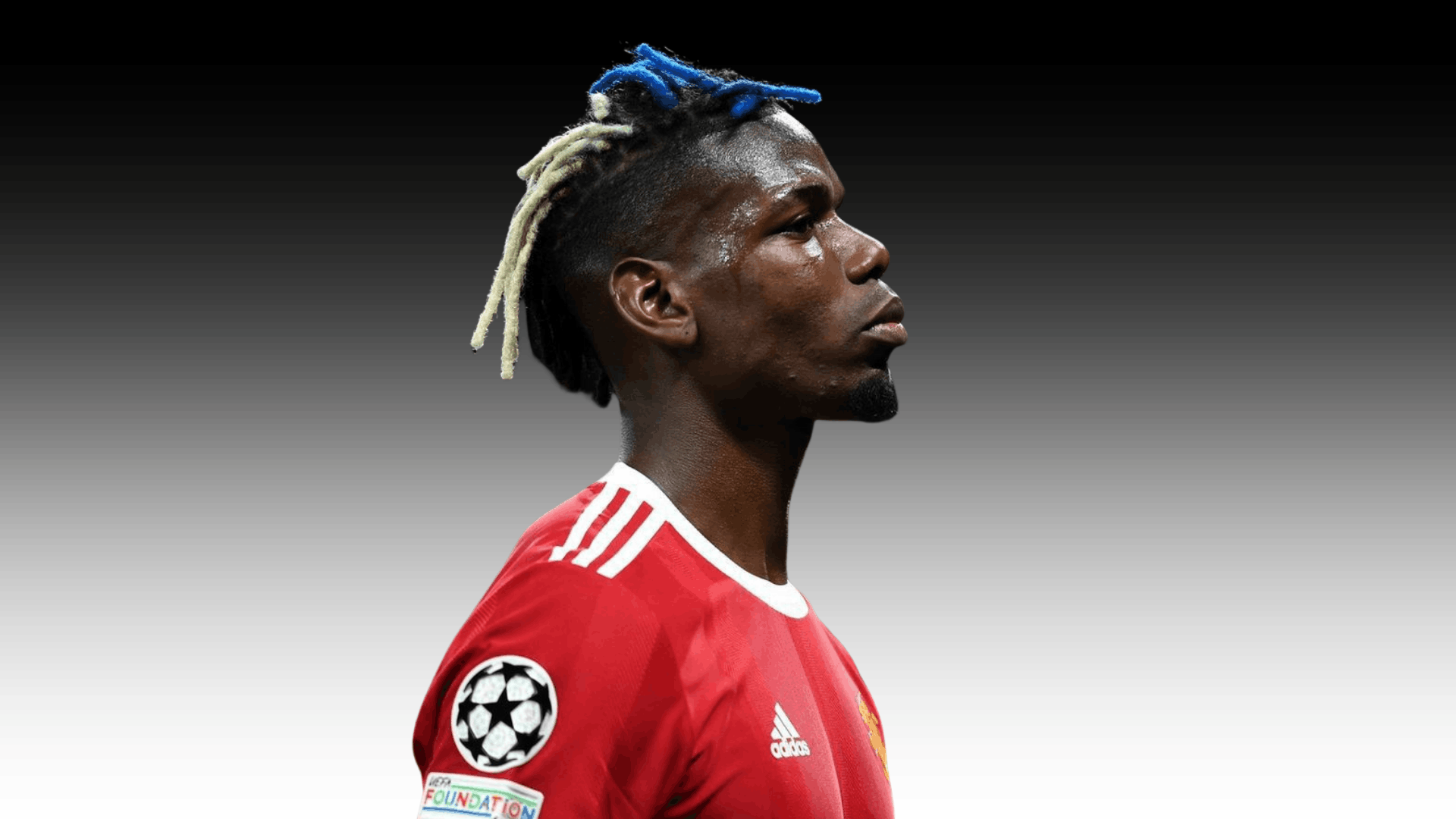 soccer player in red jersey showing colorful dyed braids with shaved sides on a dark plain background