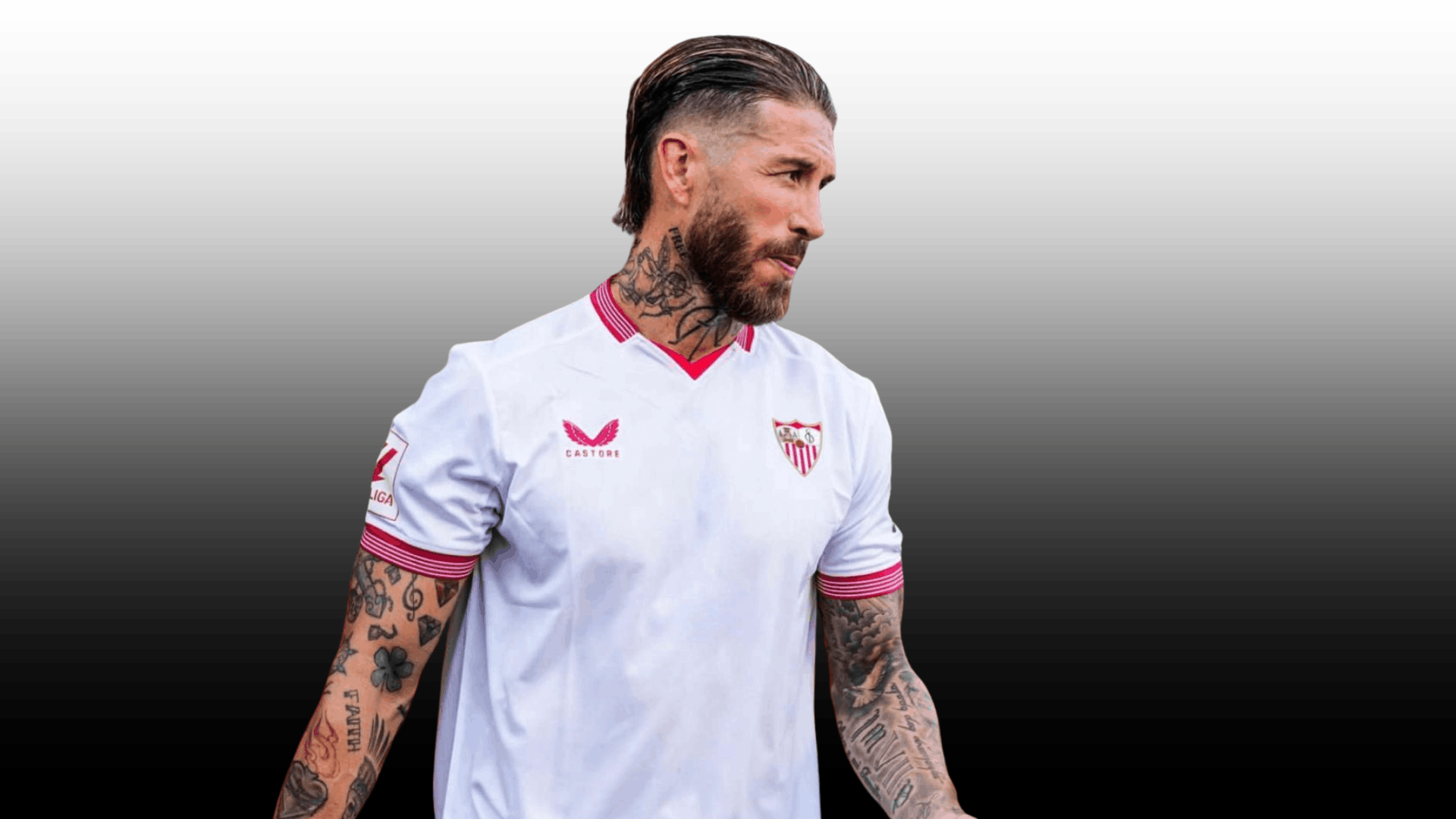 soccer player with slicked back undercut and beard wearing white jersey with arm tattoos on gray background