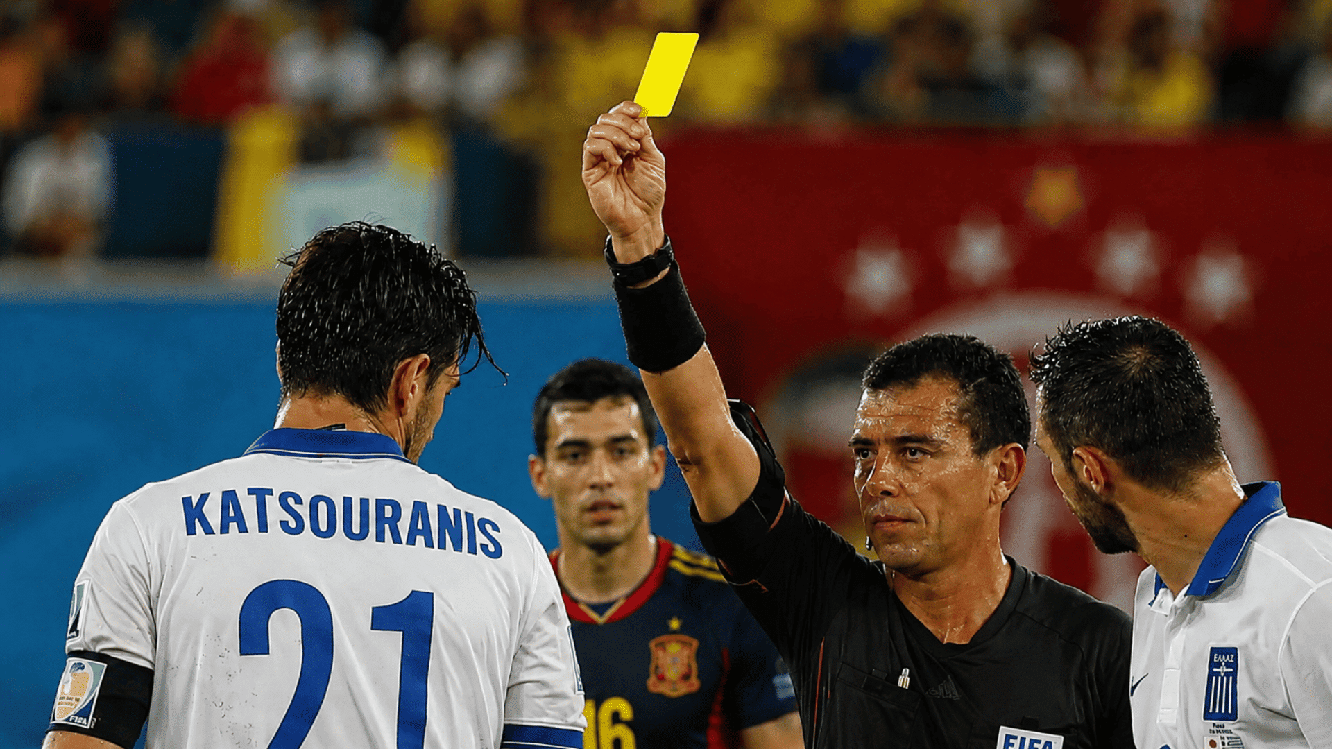 soccer referee cautioning a player as teams manage yellow card accumulation throughout a tournament (2)