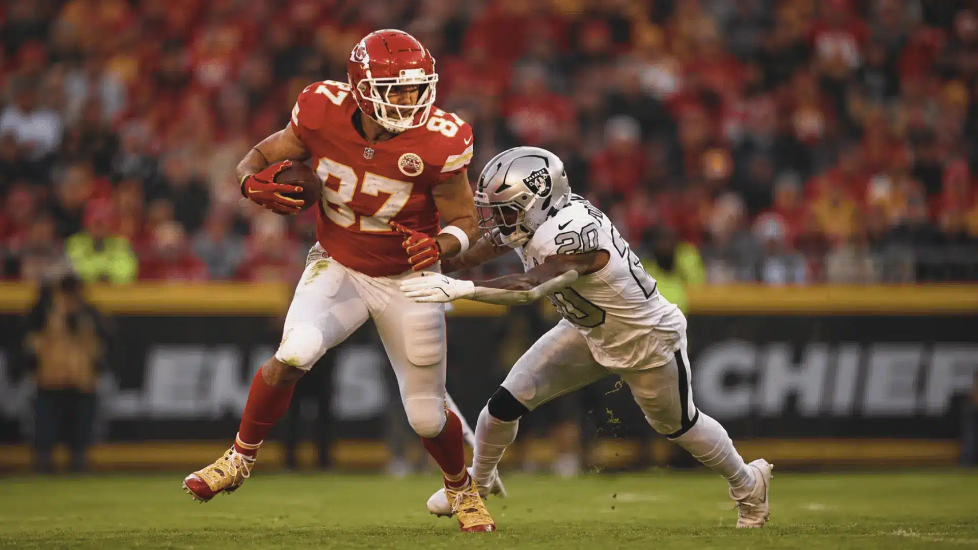 football player in red jersey runs with the ball while a defender reaches for the tackle on a football field