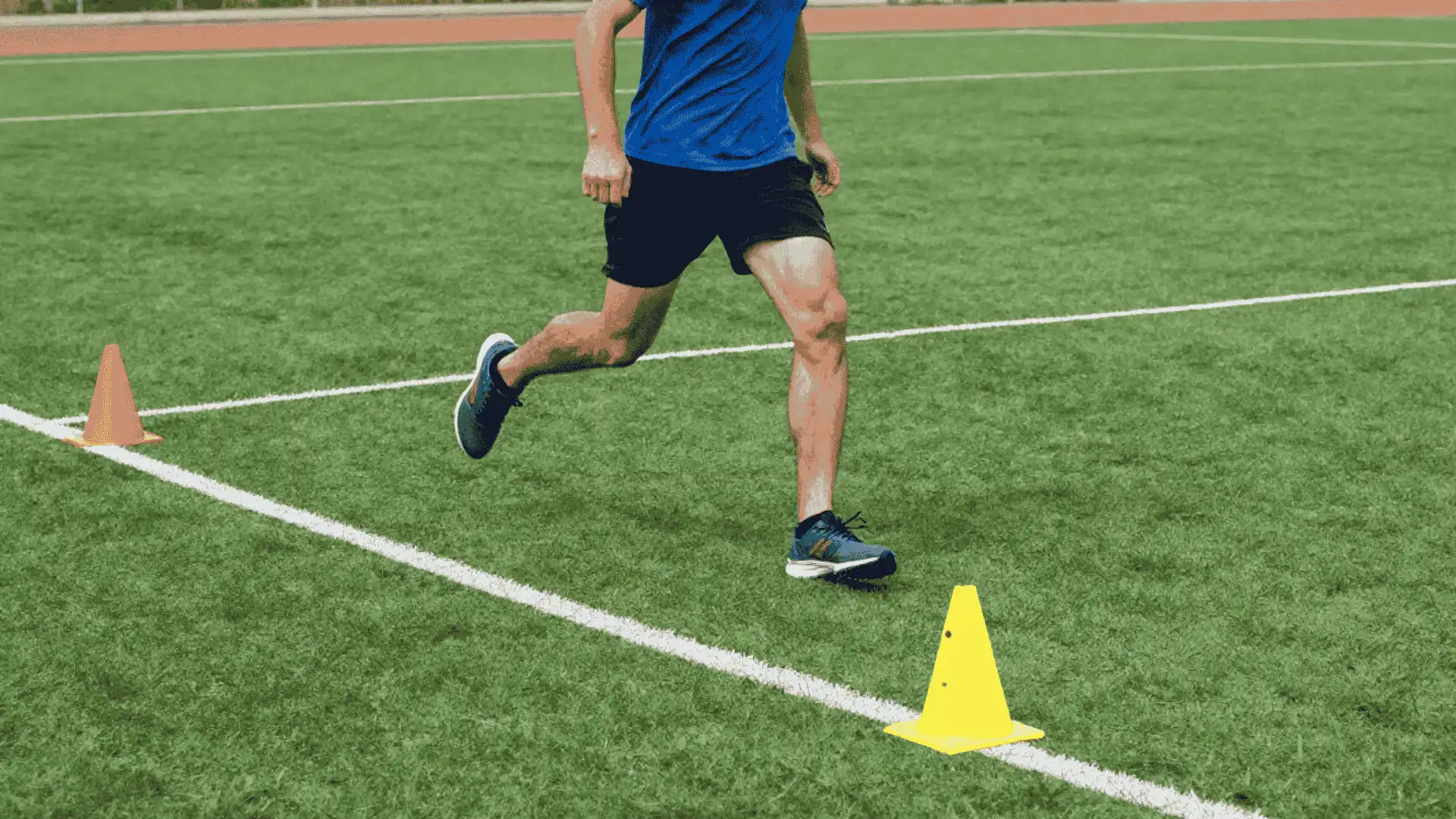 athlete changing direction around cones on turf during a three cone l drill for agility training
