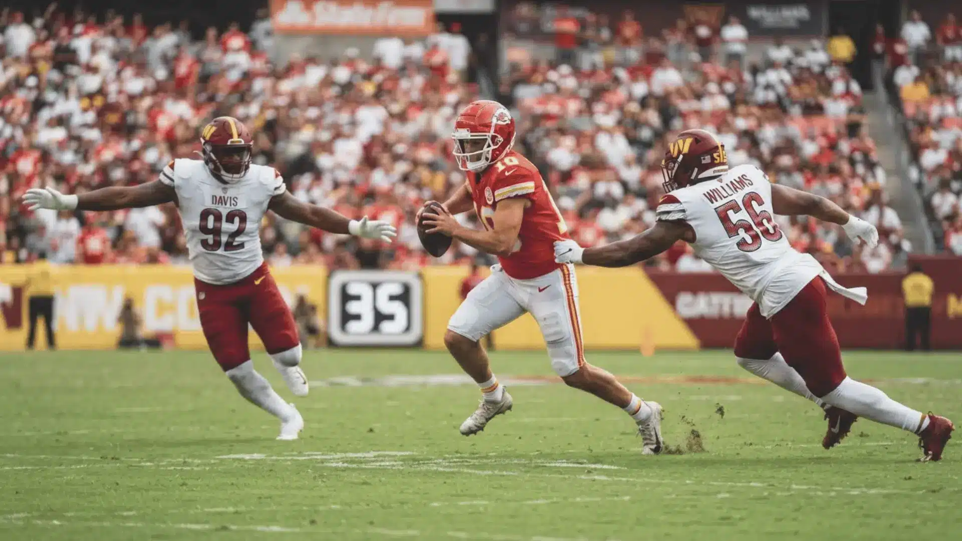 quarterback in red runs from two defenders during a fast football play on a crowded stadium field