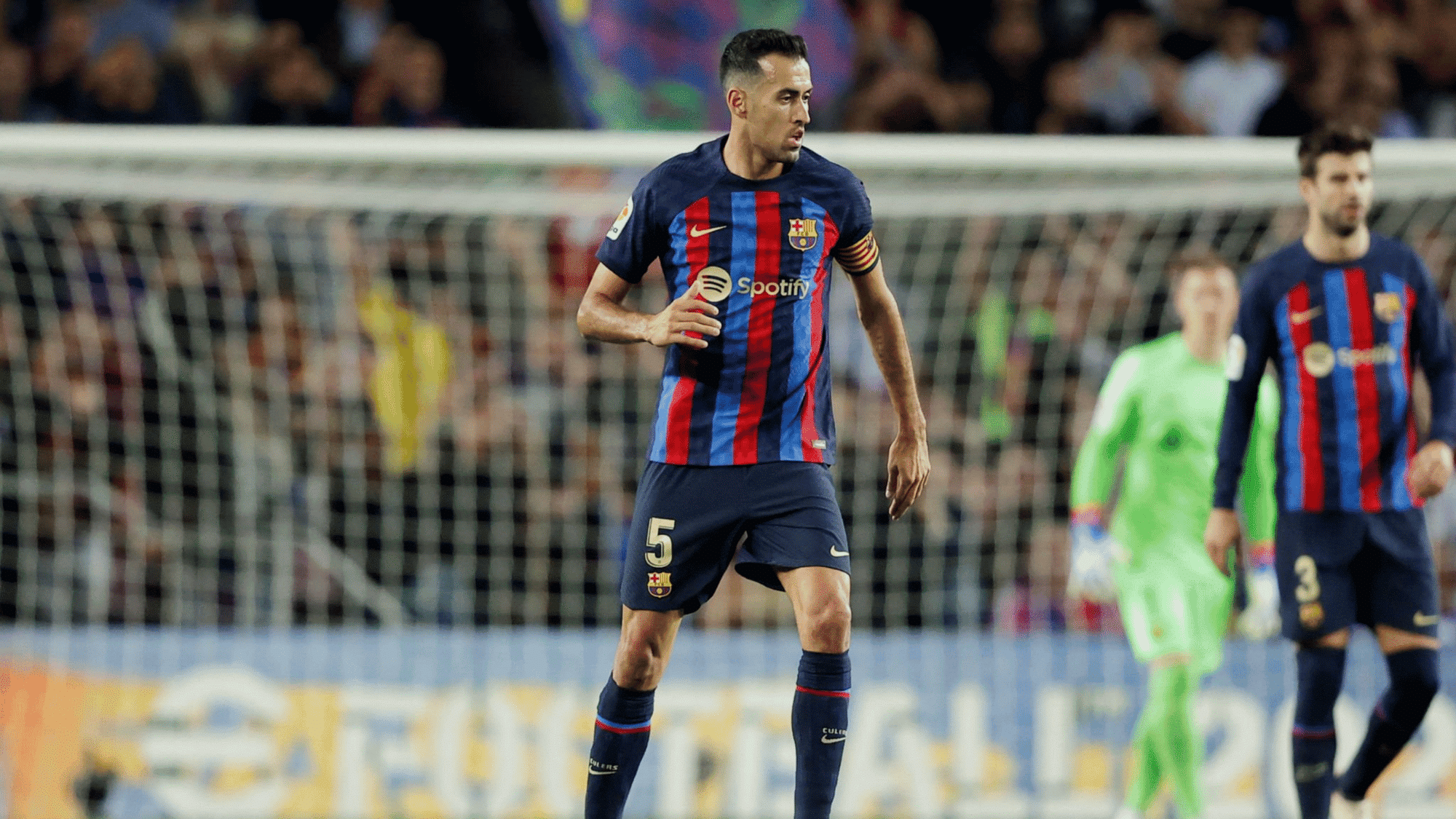 wide angle focused shot on sergio busquets in the middle of the field with wearing his barcelona jersey