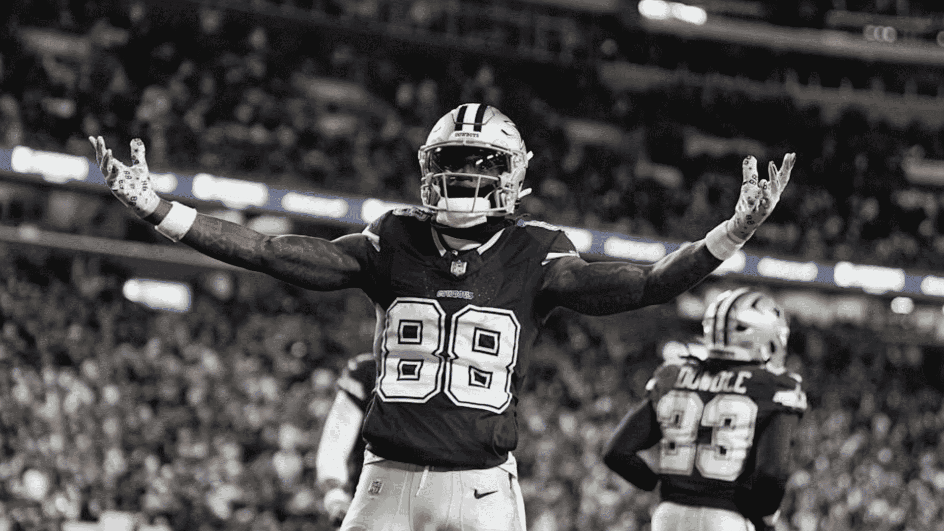 ceedee lamb raises both arms during a dallas cowboys game