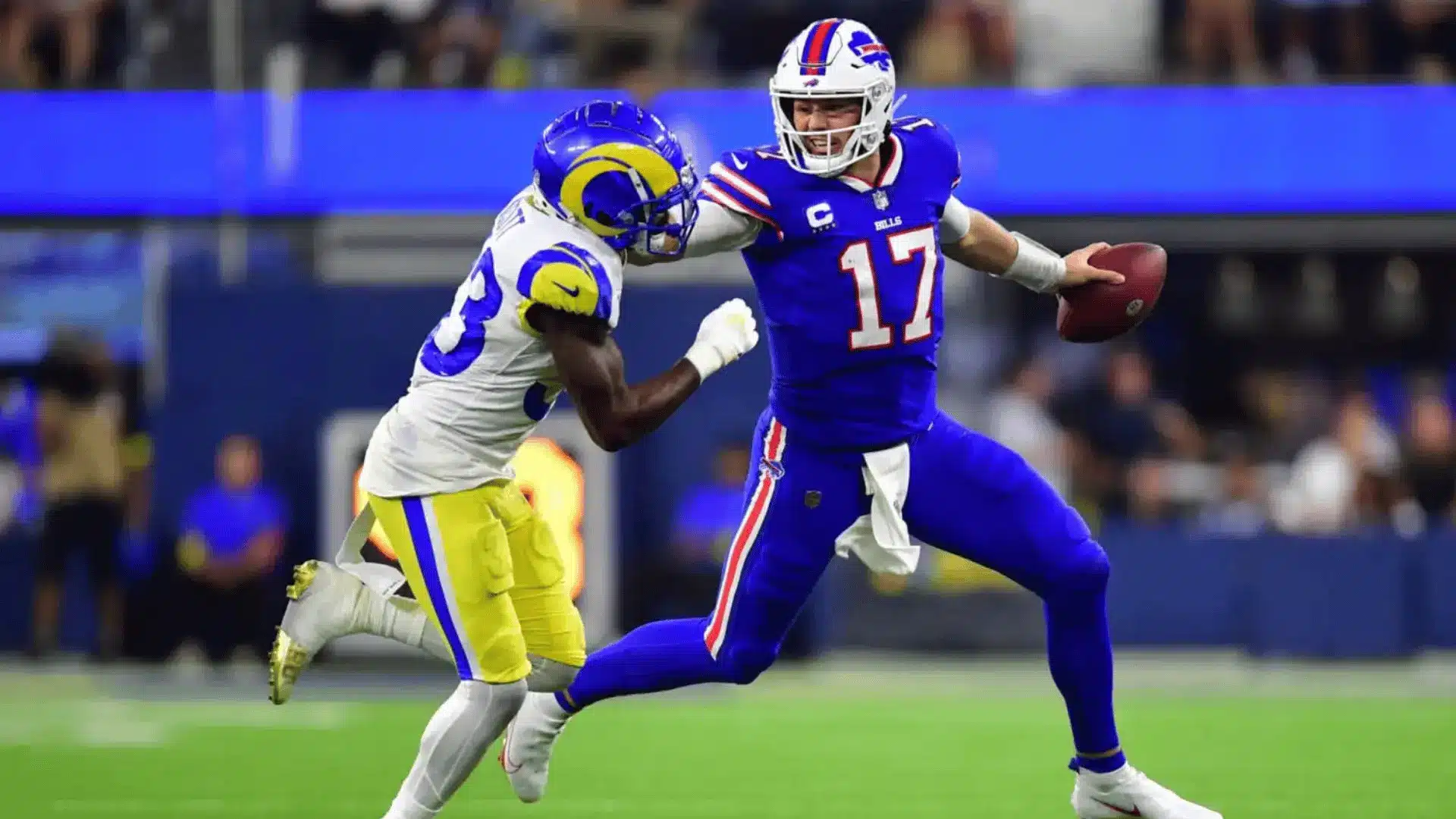 football quarterback escaping pressure from defender while carrying ball during game action