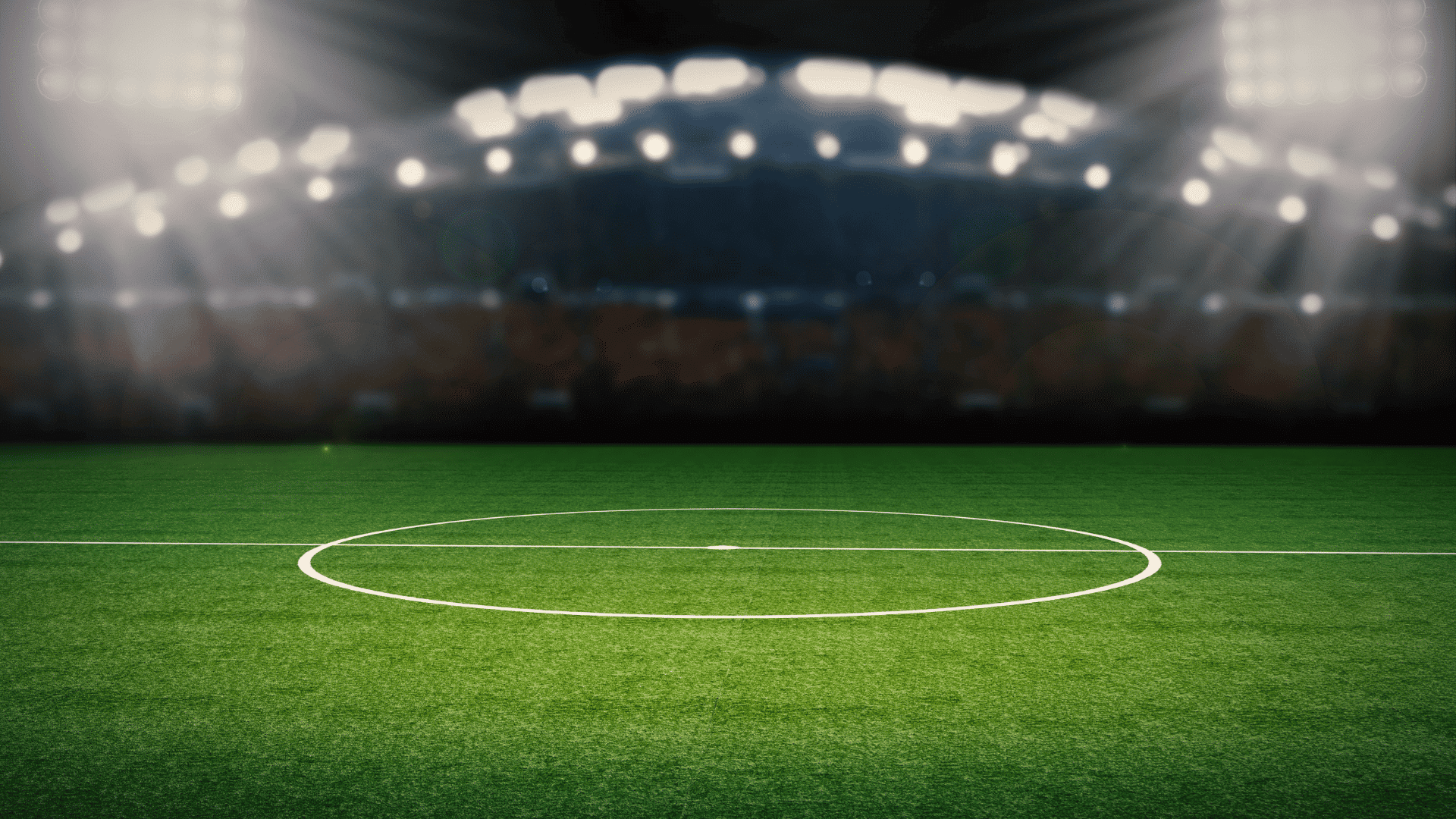 soccer field center circle under stadium lights with green grass and clear white field markings