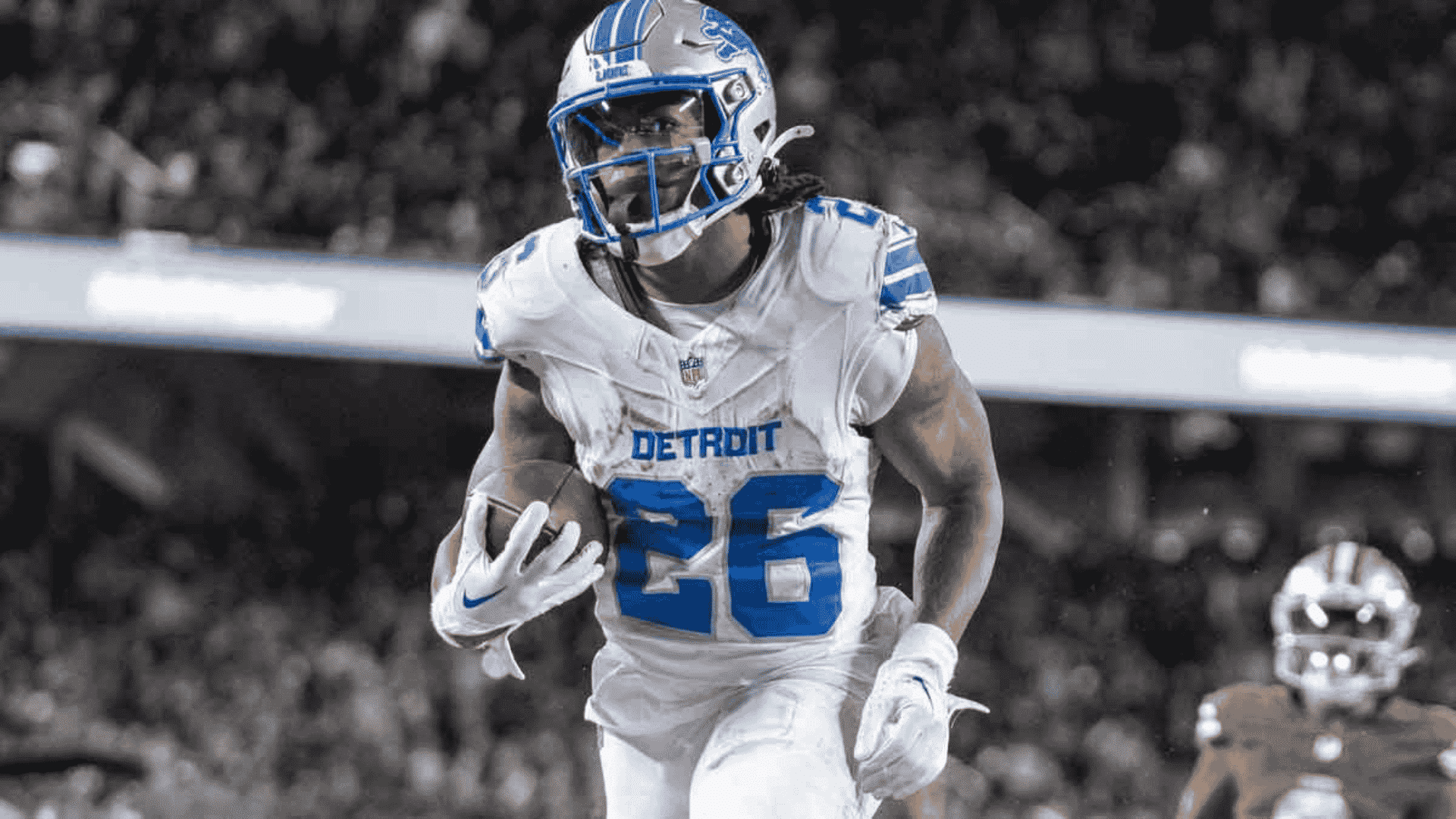 jahmyr gibbs runs with the football in a detroit lions uniform