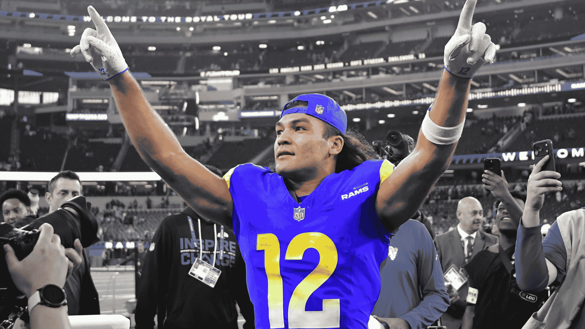 puka nacua points upward while wearing a los angeles rams uniform