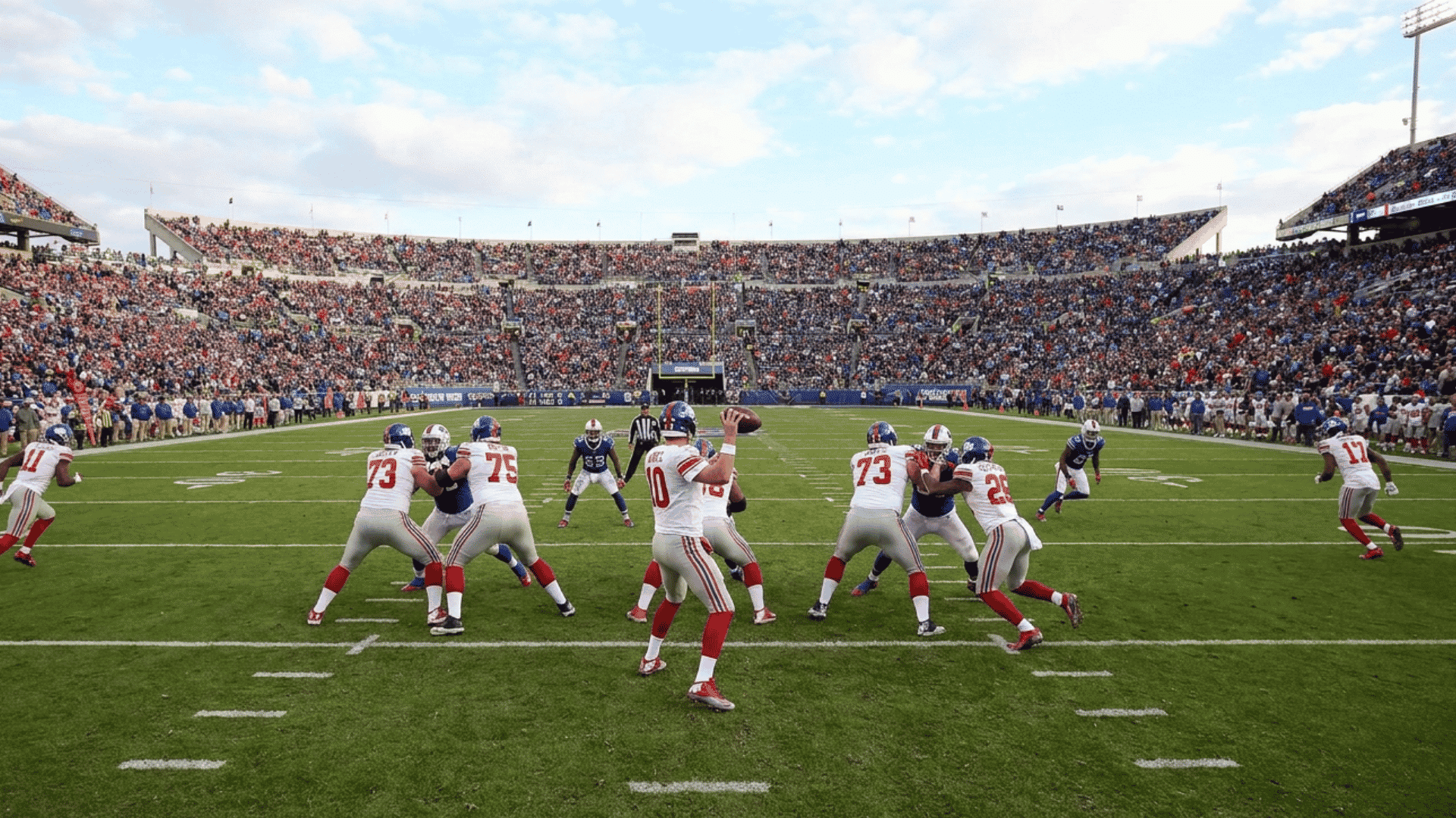 quarterback stands behind the center before the snap while reading the defense and directing the offense
