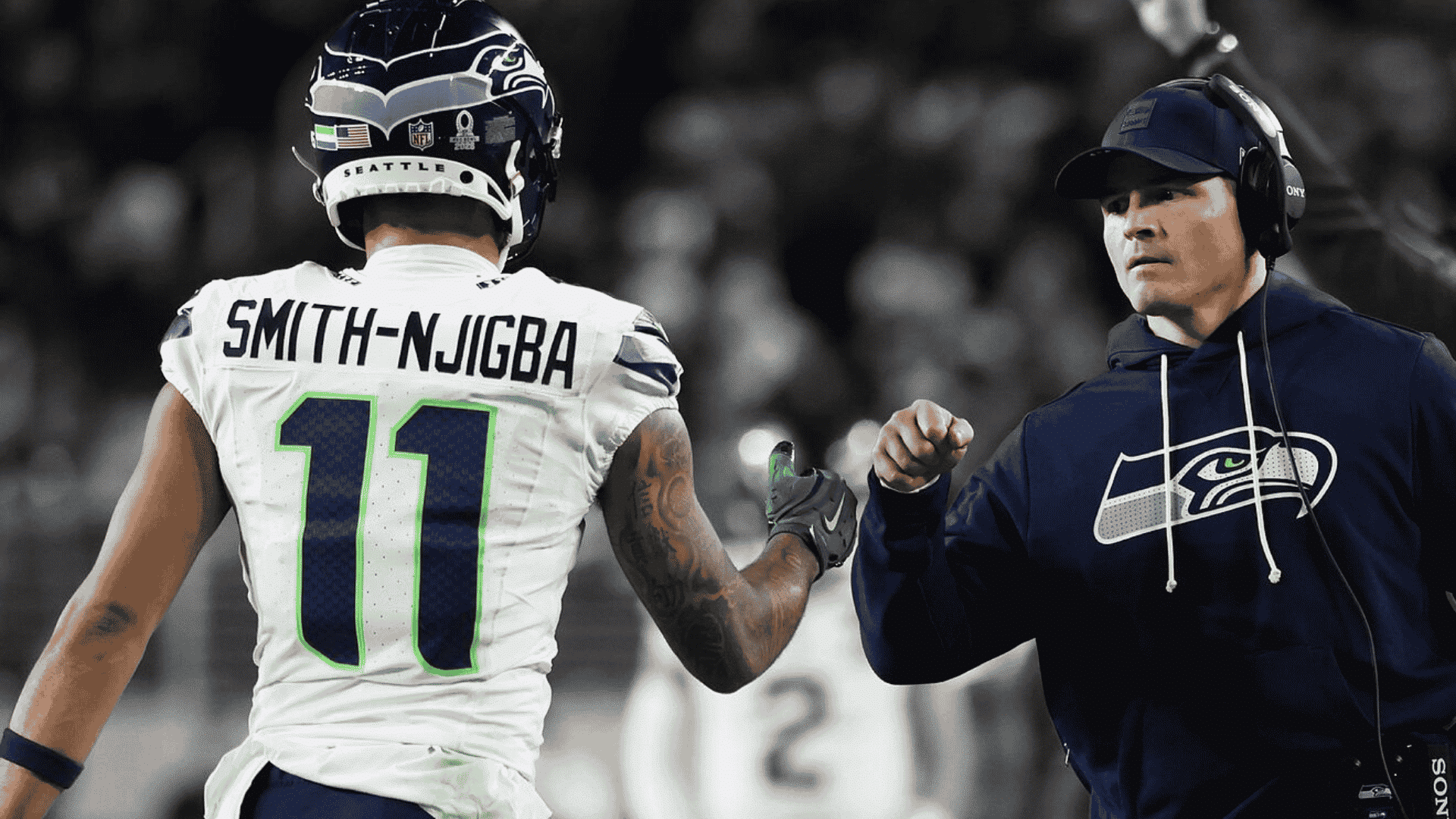 jaxon smith njigba fist bumps a seattle seahawk for best draft position in fantasy football