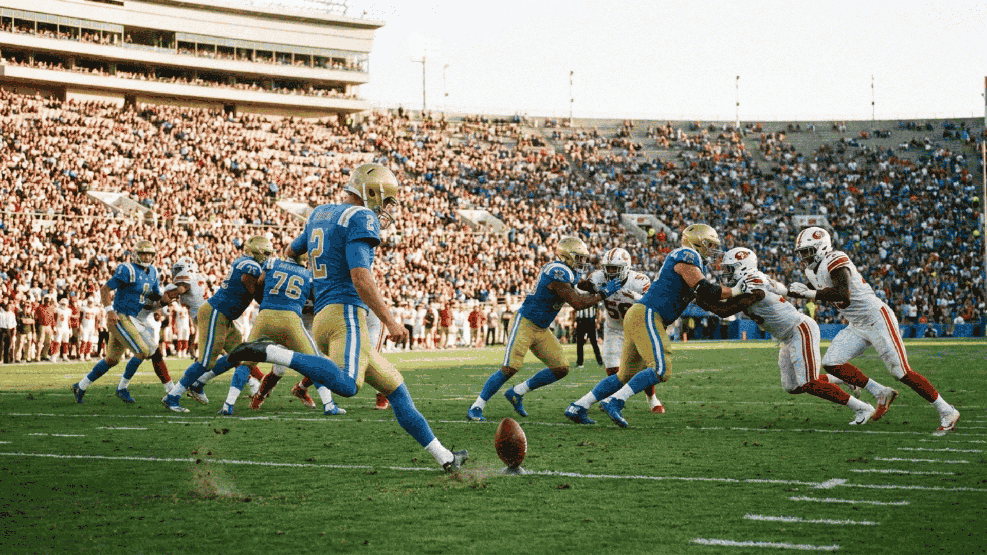 kicker strikes an onside kick during a crowded football game in a large stadium