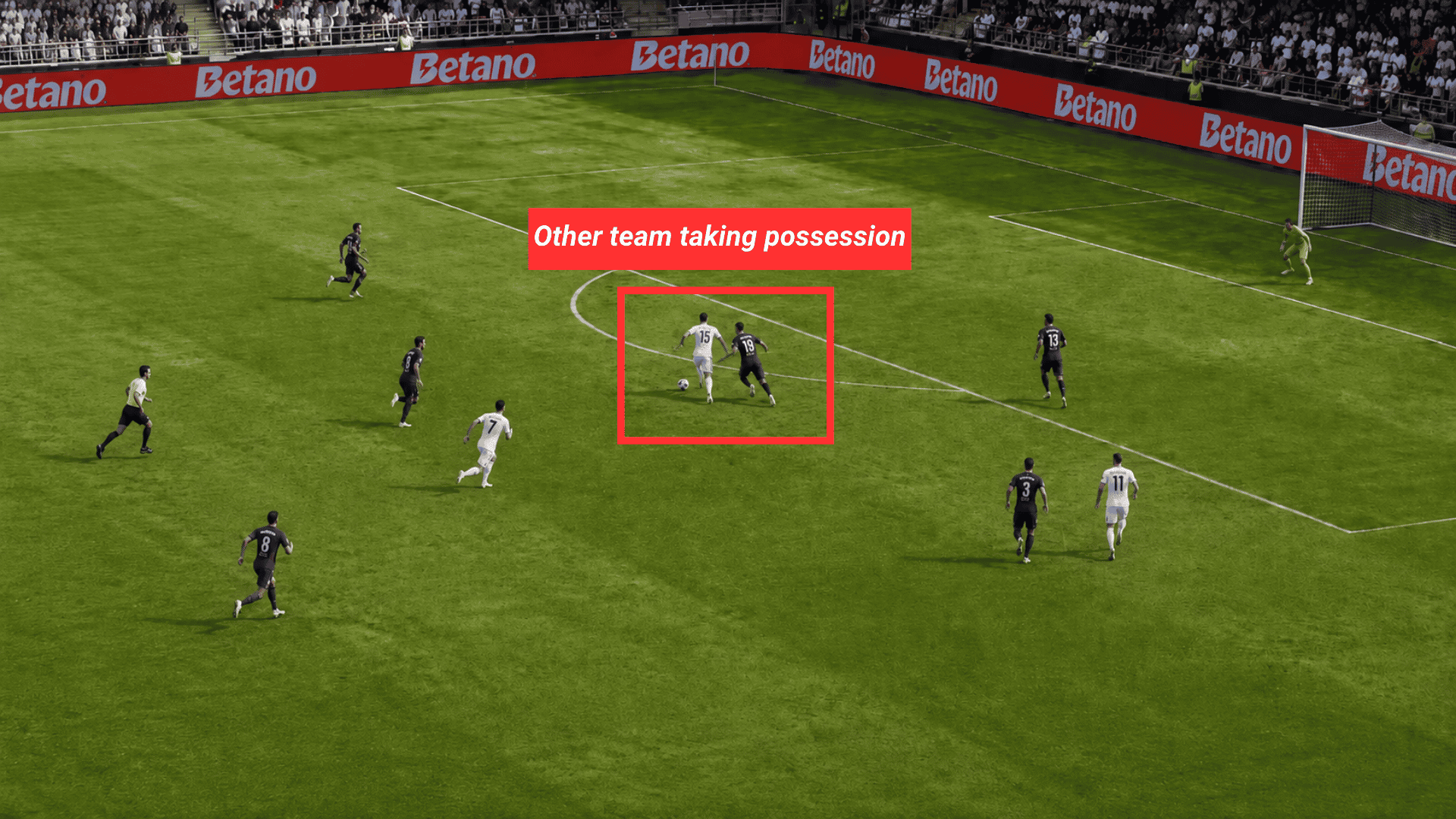 white team player takes possession of the ball while a dark team defender pressures him near the penalty area