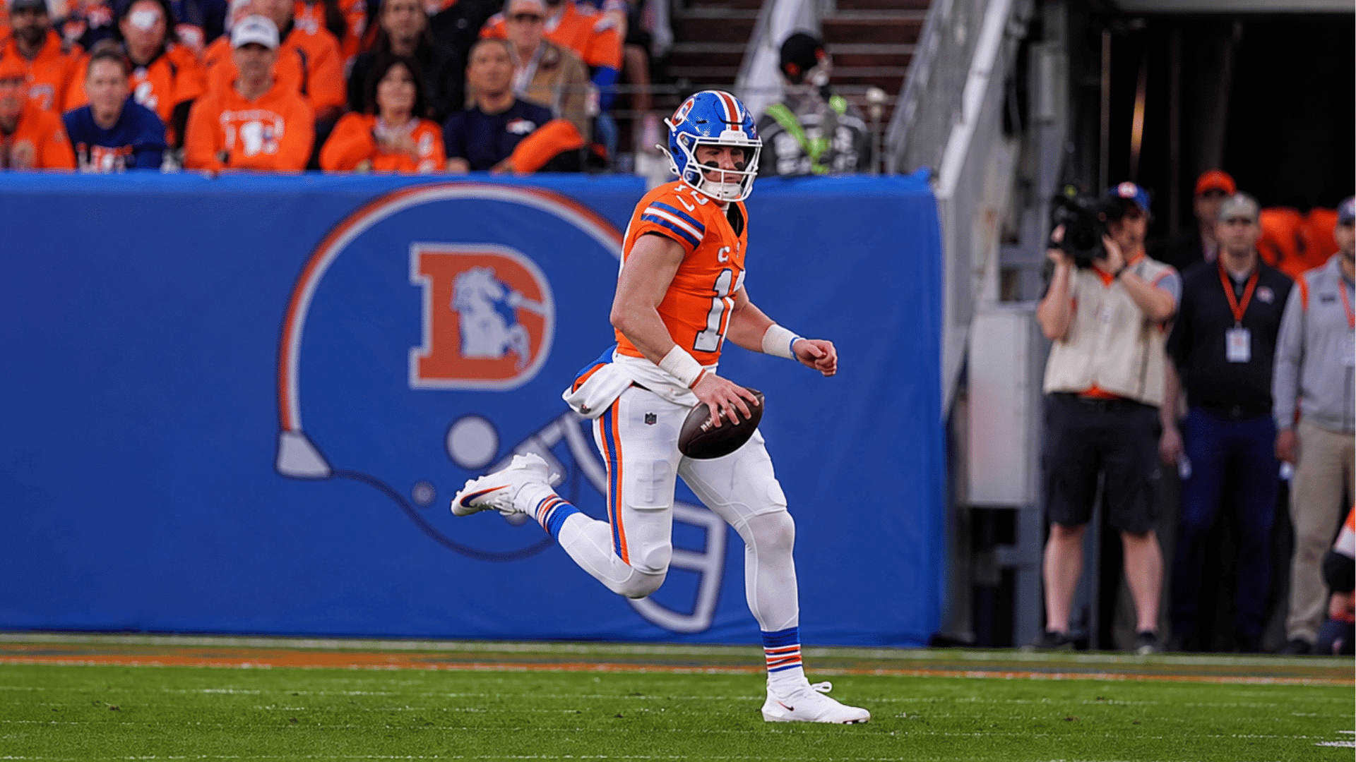denver broncos quarterback runs with football during game
