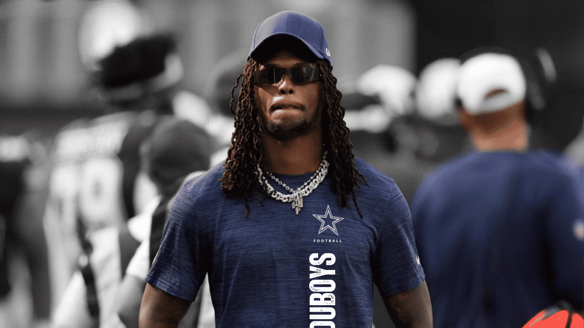 cowboys player ceedee lamb wearing sunglasses cap and navy team shirt during practice