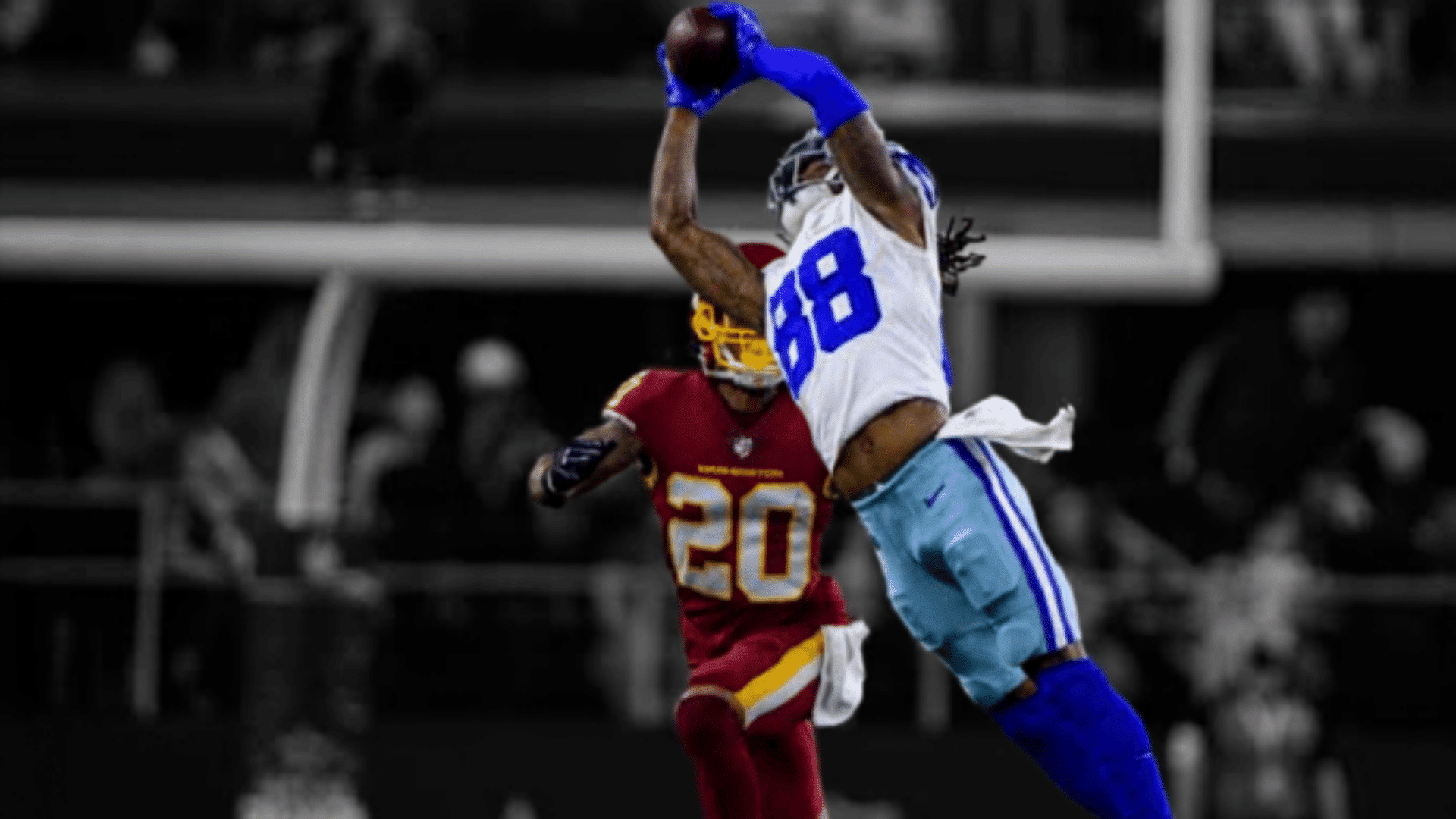 dallas cowboys receiver making a leaping catch over a washington defender