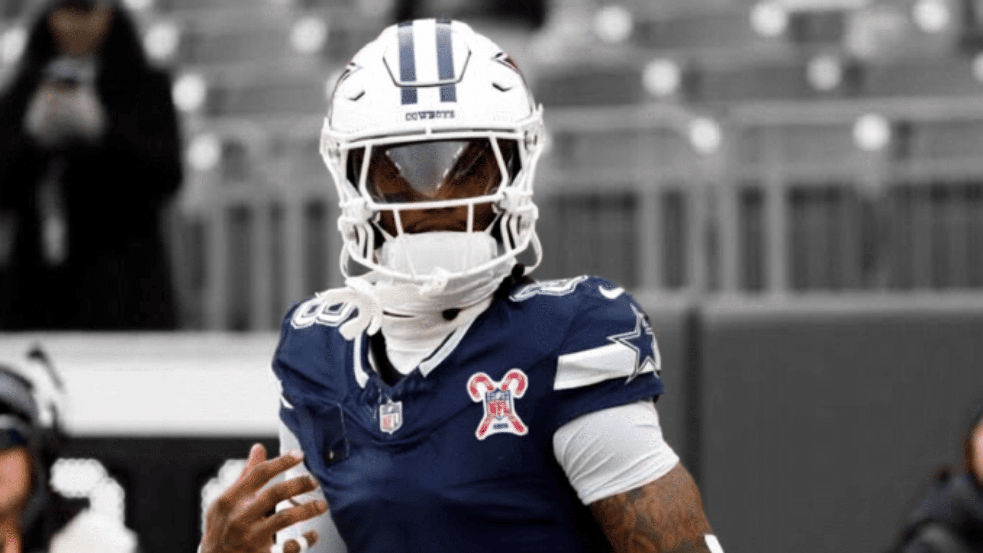 close up of cowboys number eighty eight wearing a navy jersey and helmet