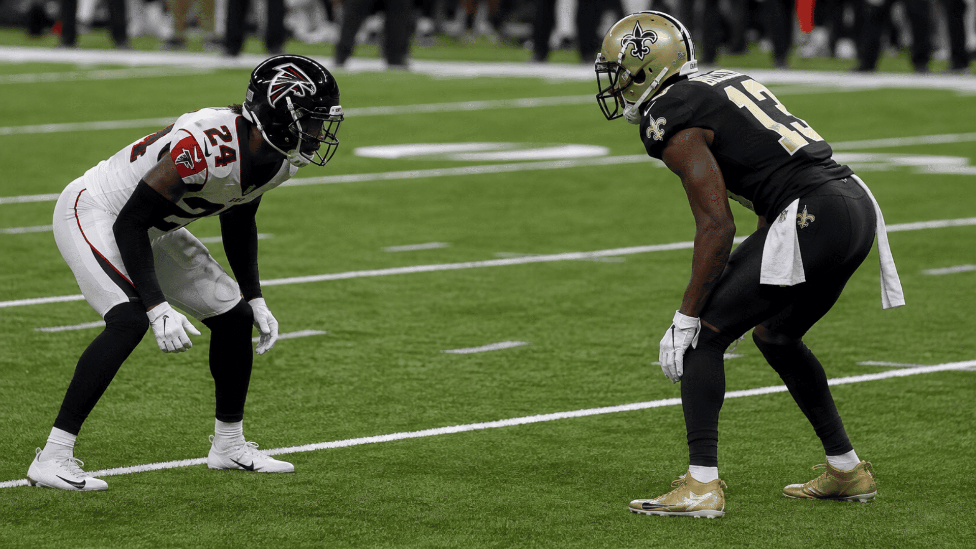 cornerback lined up across from a wide receiver before the snap on a football field