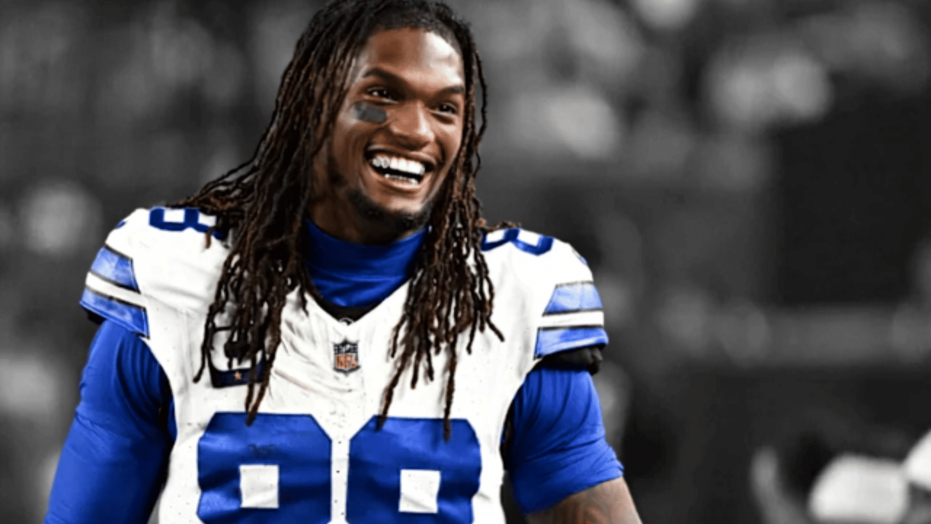 dallas cowboys wide receiver smiling in a white number eighty eight jersey