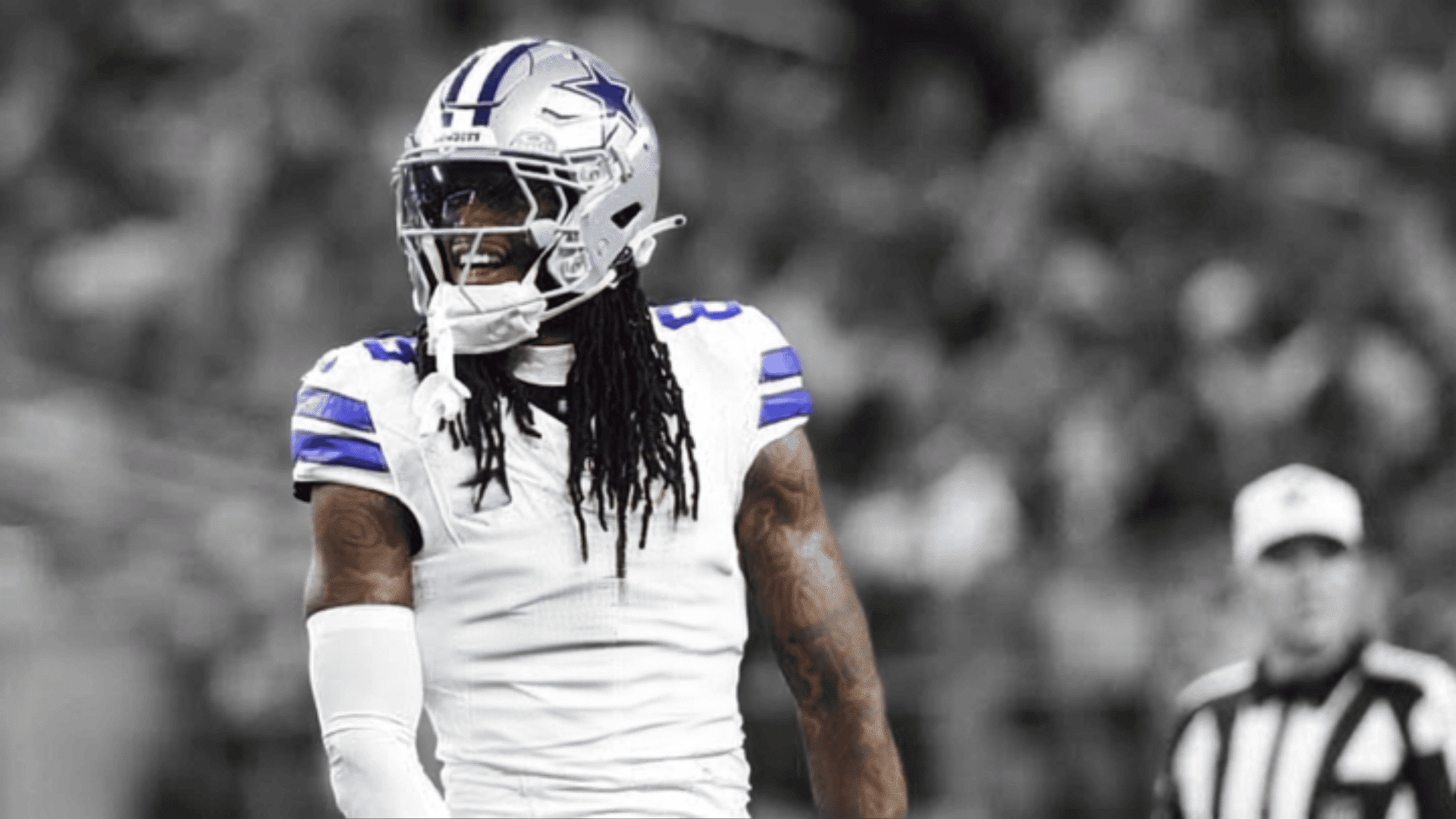 dallas cowboys wide receiver standing on the field in a white uniform