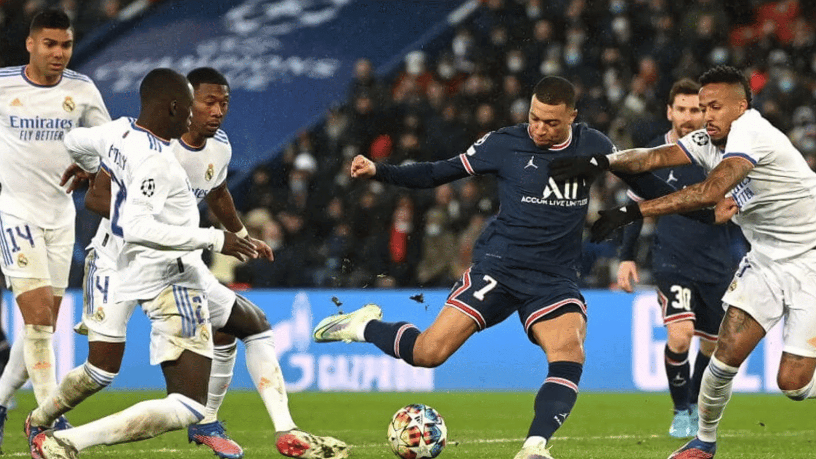 football forward takes a shot while several defenders close in during a match