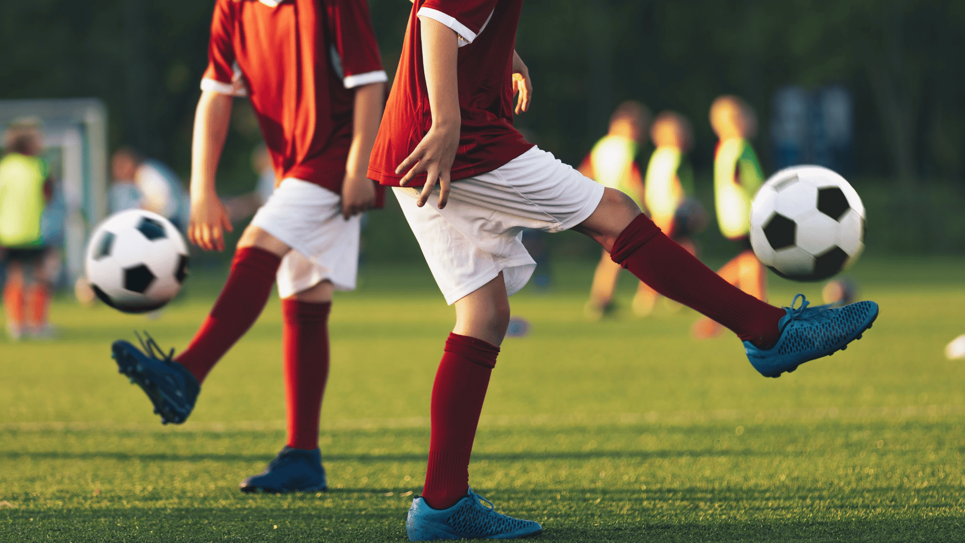 young soccer players practicing ball control on a field while training to become professional players