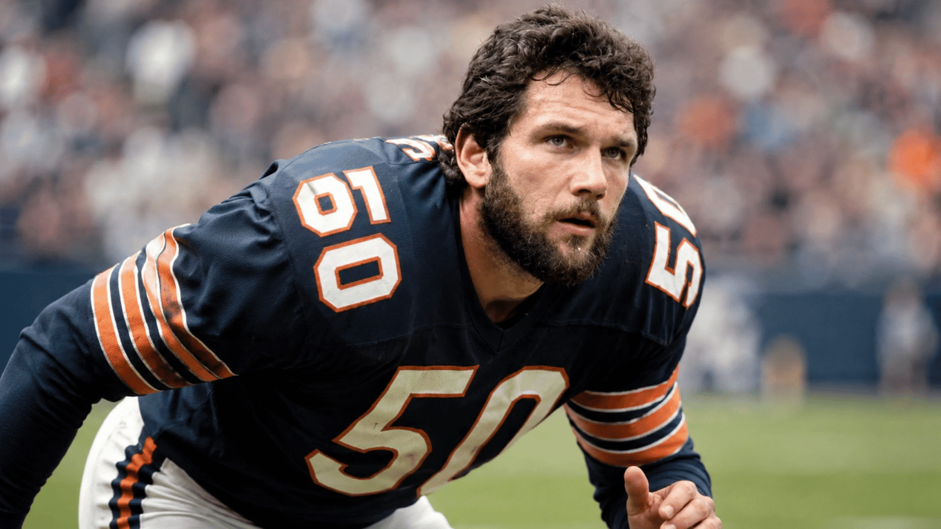 jack ham crouching in a defensive stance while watching the play develop on the field